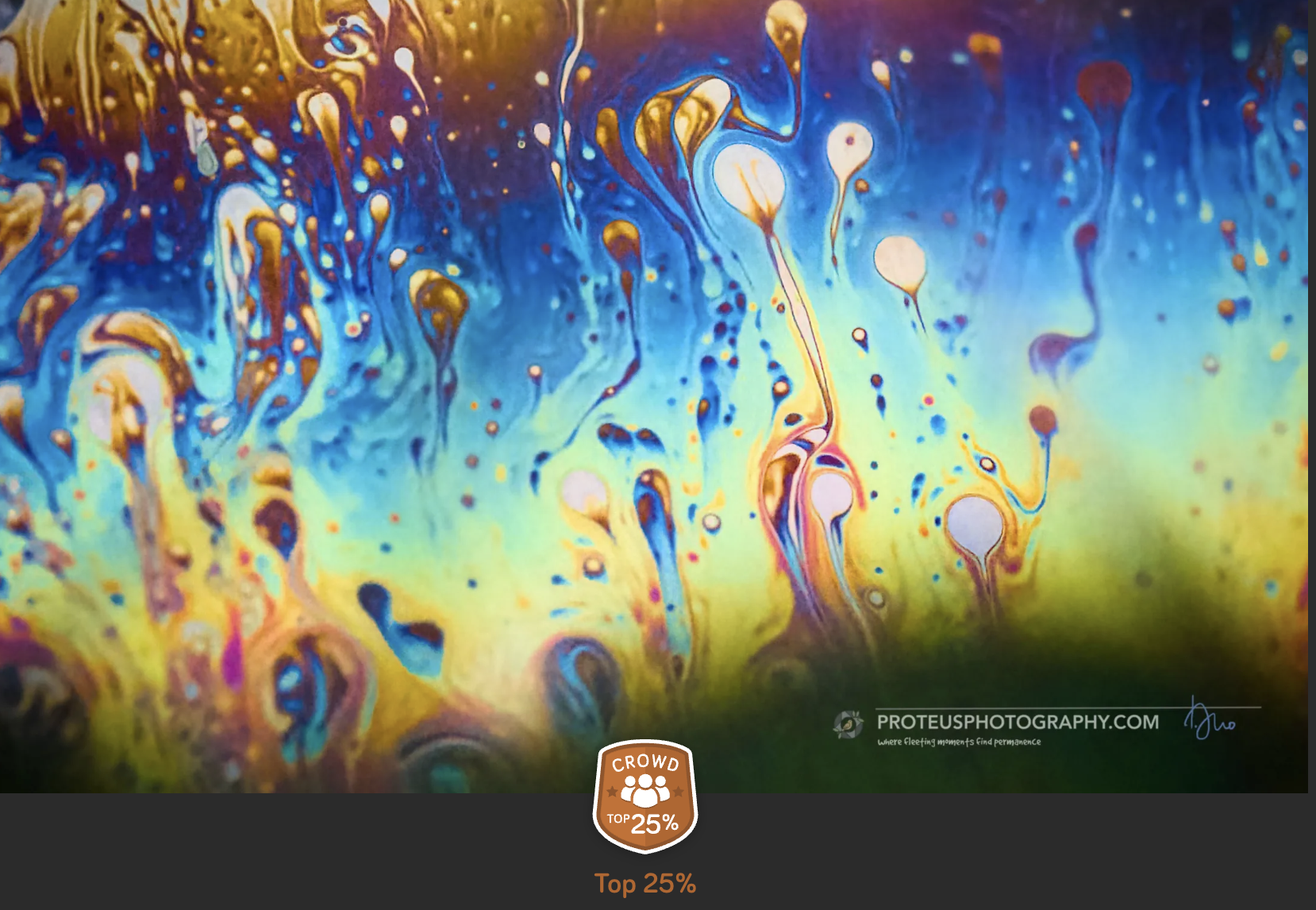 Abstract colorful paint swirling with yellow, blue, purple, and green hues creating patterns and textures.