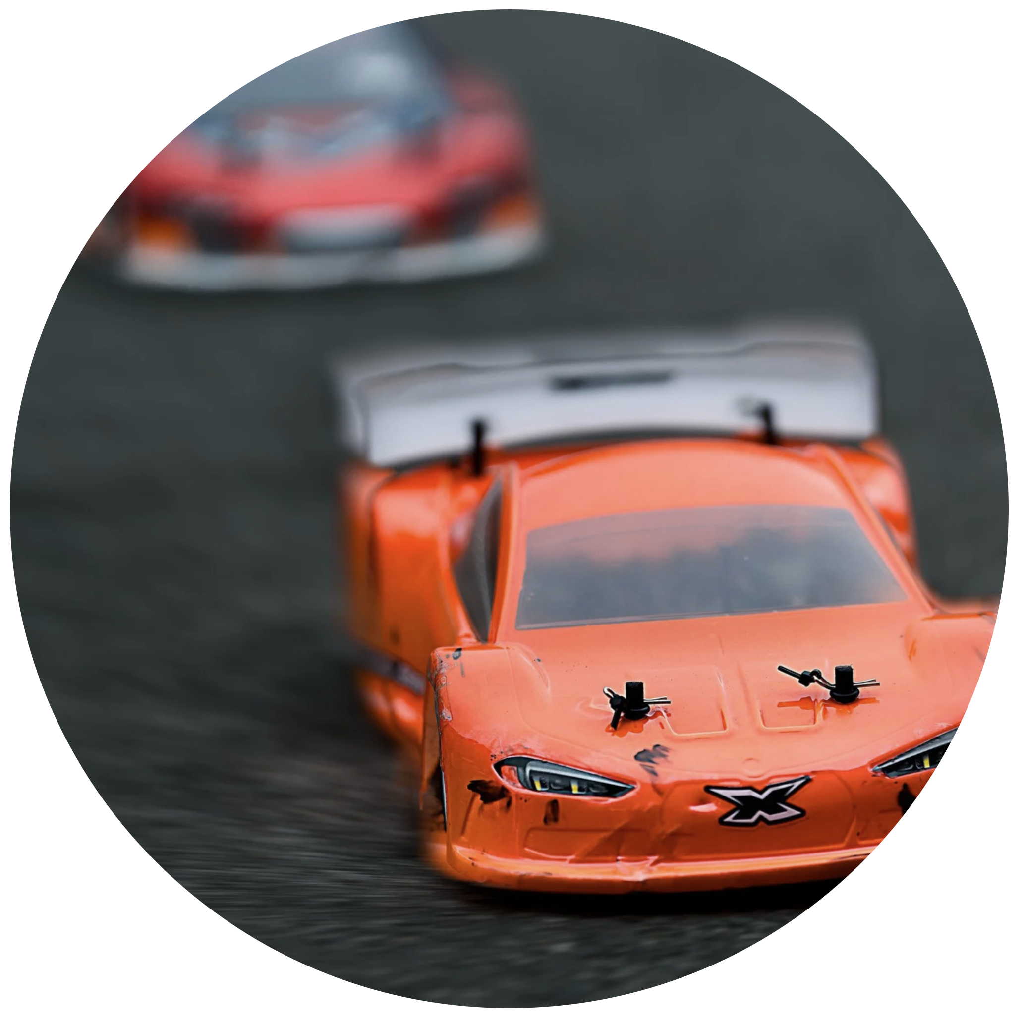 Red race car on a dark racing track.