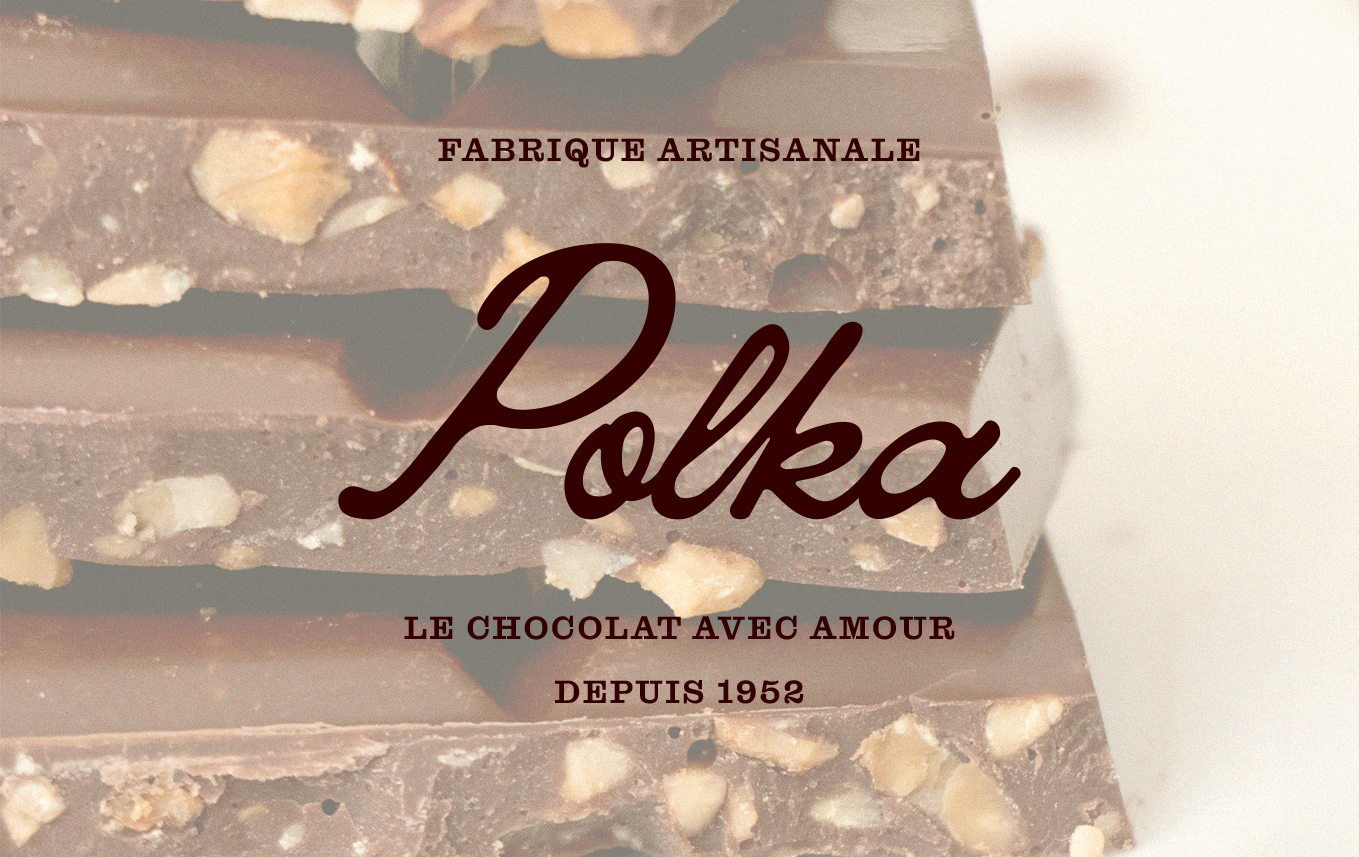 Une image montrant des morceaux de chocolat avec des noisettes, accompagnée du texte en français : "Fabrique artisanale Polka, le chocolat avec amour depuis 1952".