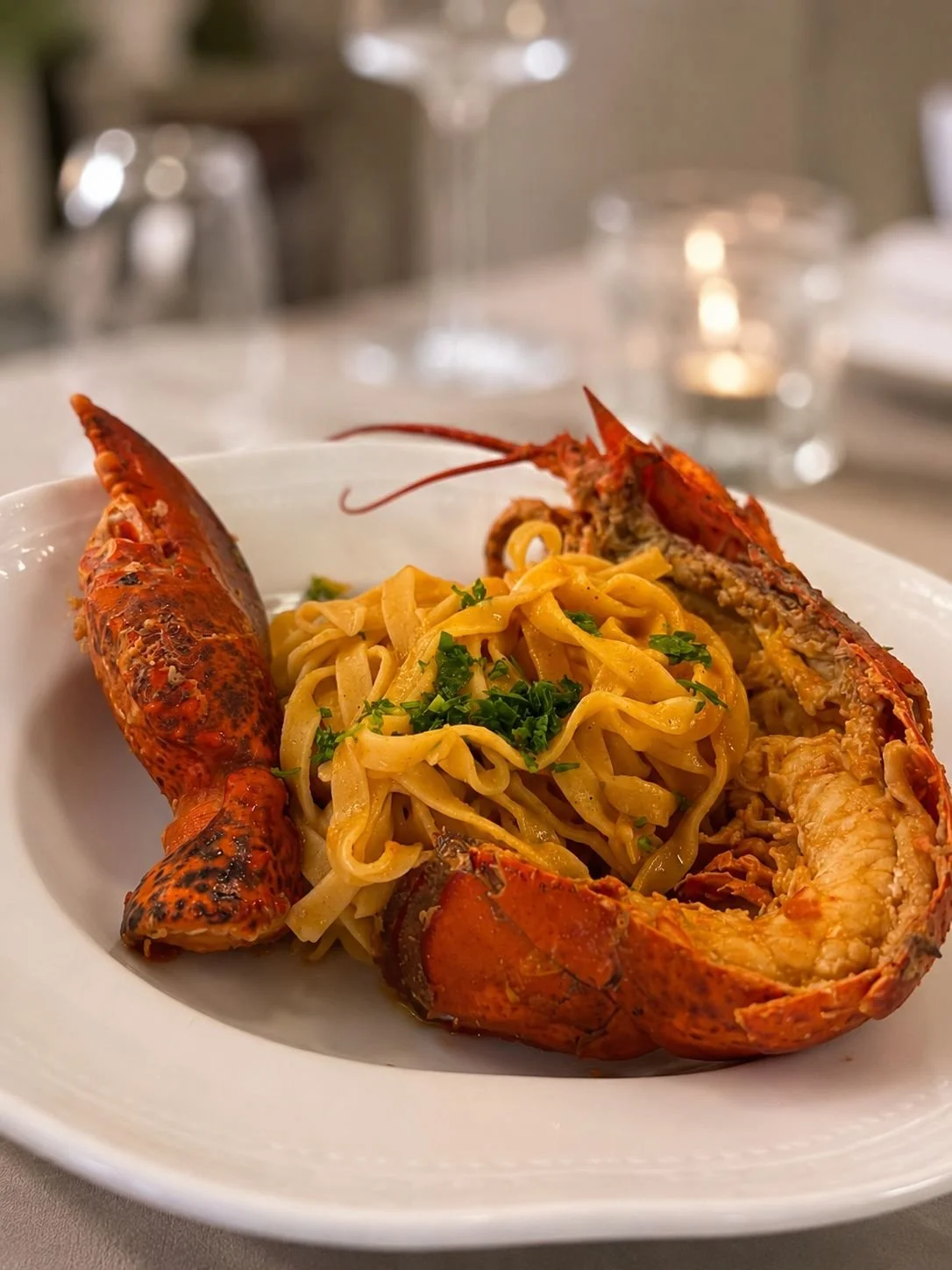 Lobster served with fresh pasta at Cipressino restaurant in Tuscany