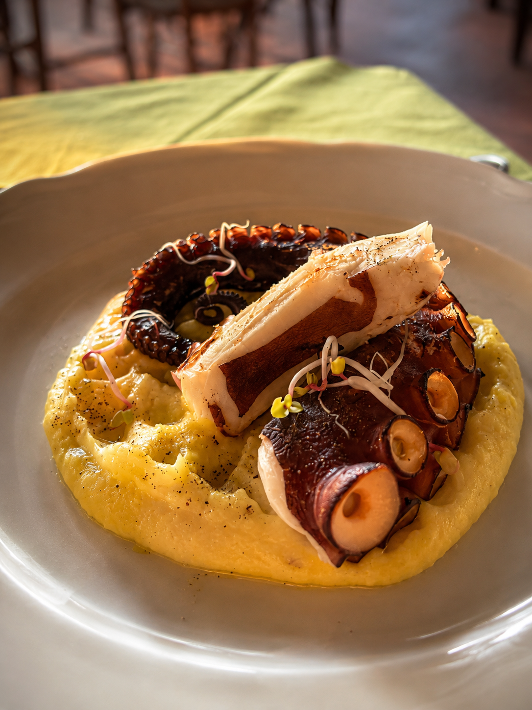 Grilled octopus and fish served with creamy polenta at Cipressino