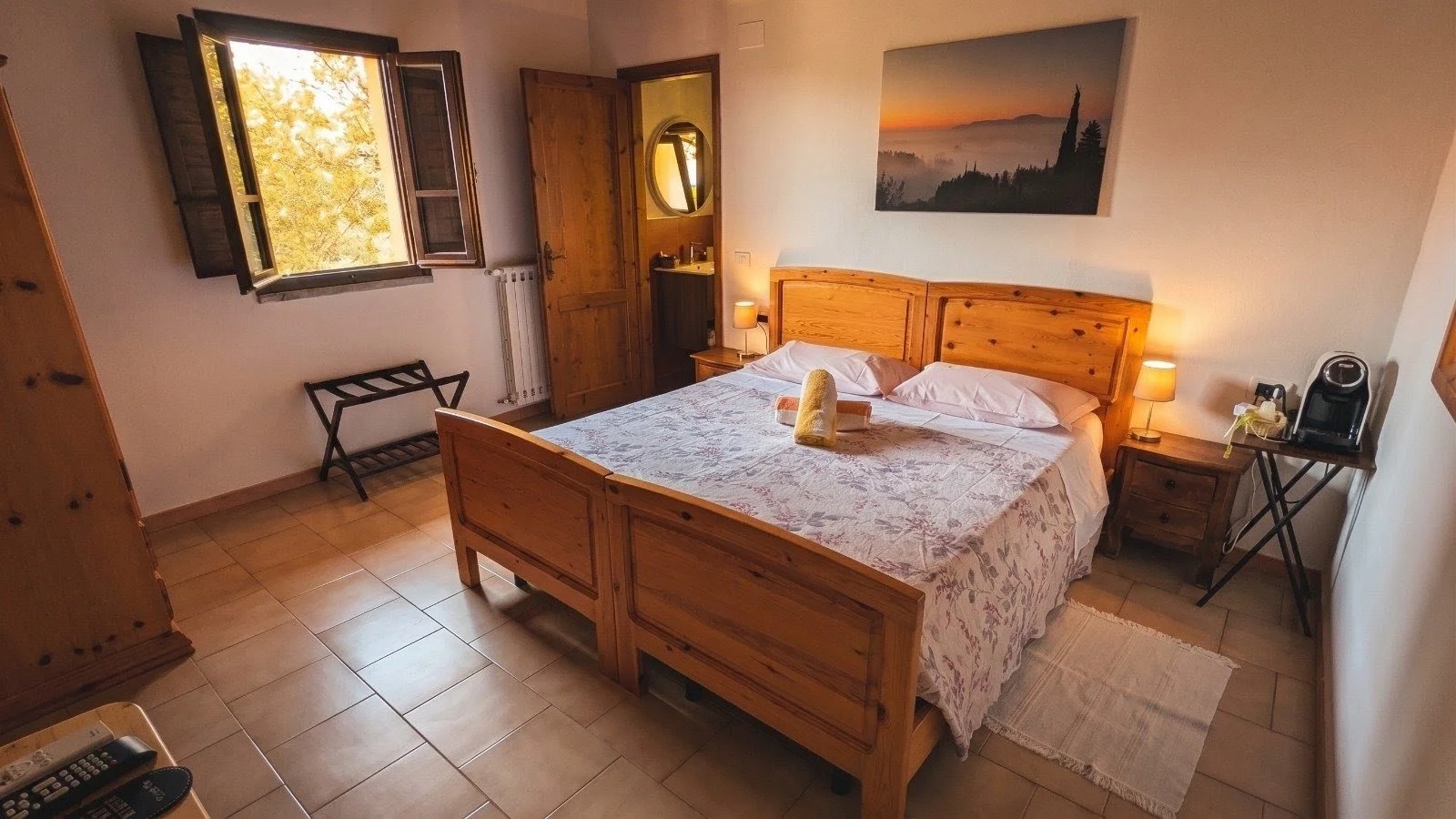 Beautiful room with a double bed wit a window looking out on the Tuscan Hills.