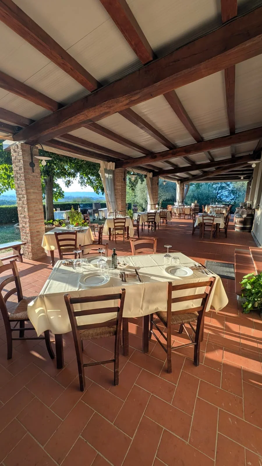 Outdoor terrace of Cipressino restaurant overlooking the Tuscan countryside