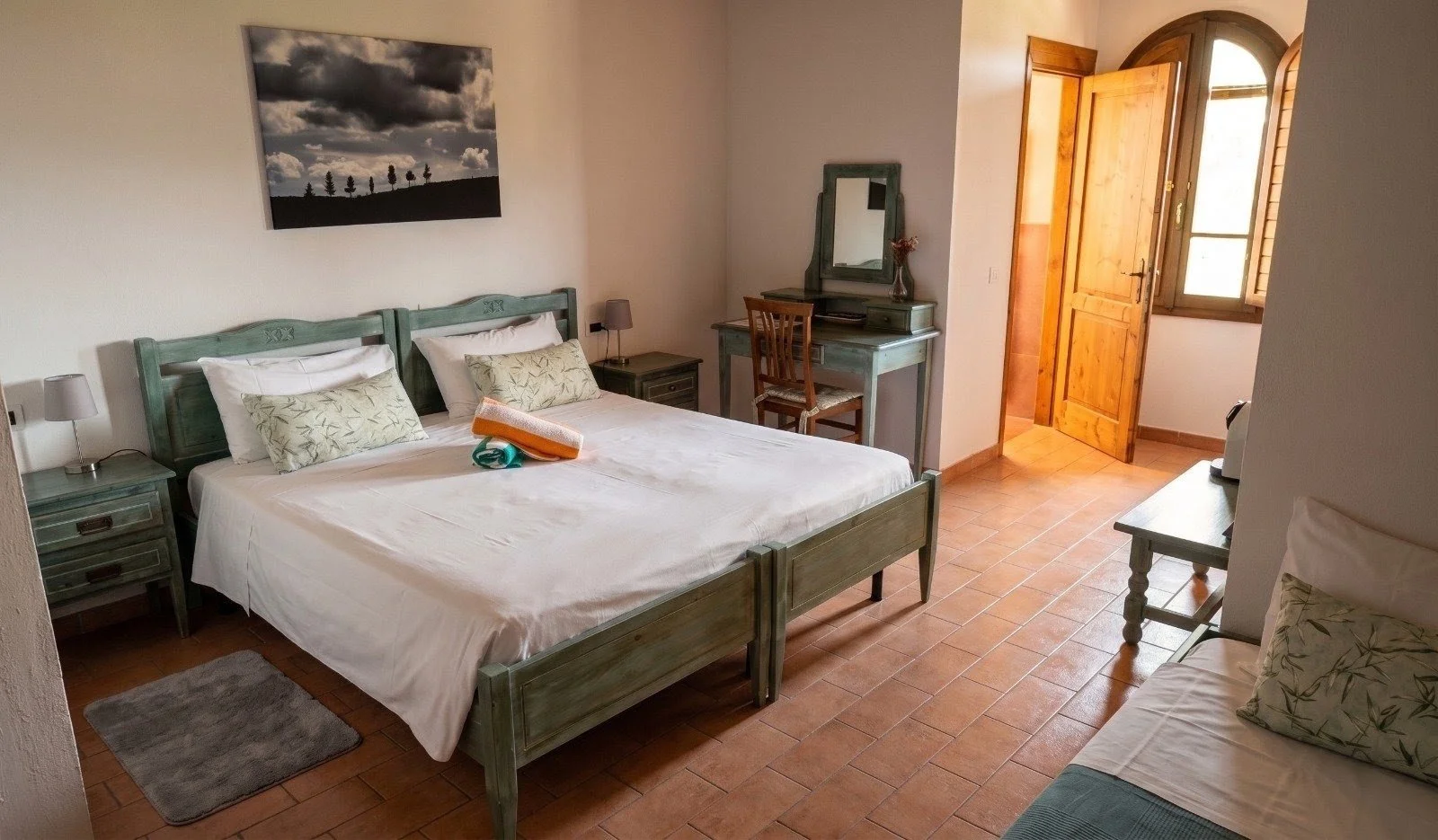 Beautiful room with a double bed wit a window looking out on the Tuscan Hills.