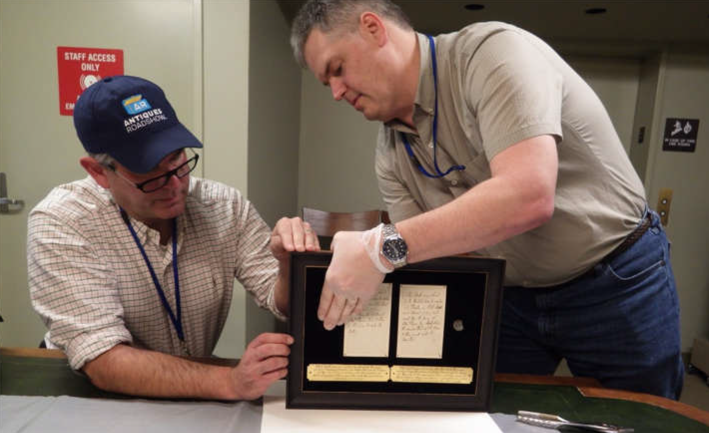 Joel Bohy and Chris Fox examine Boston Massacre musket balls.