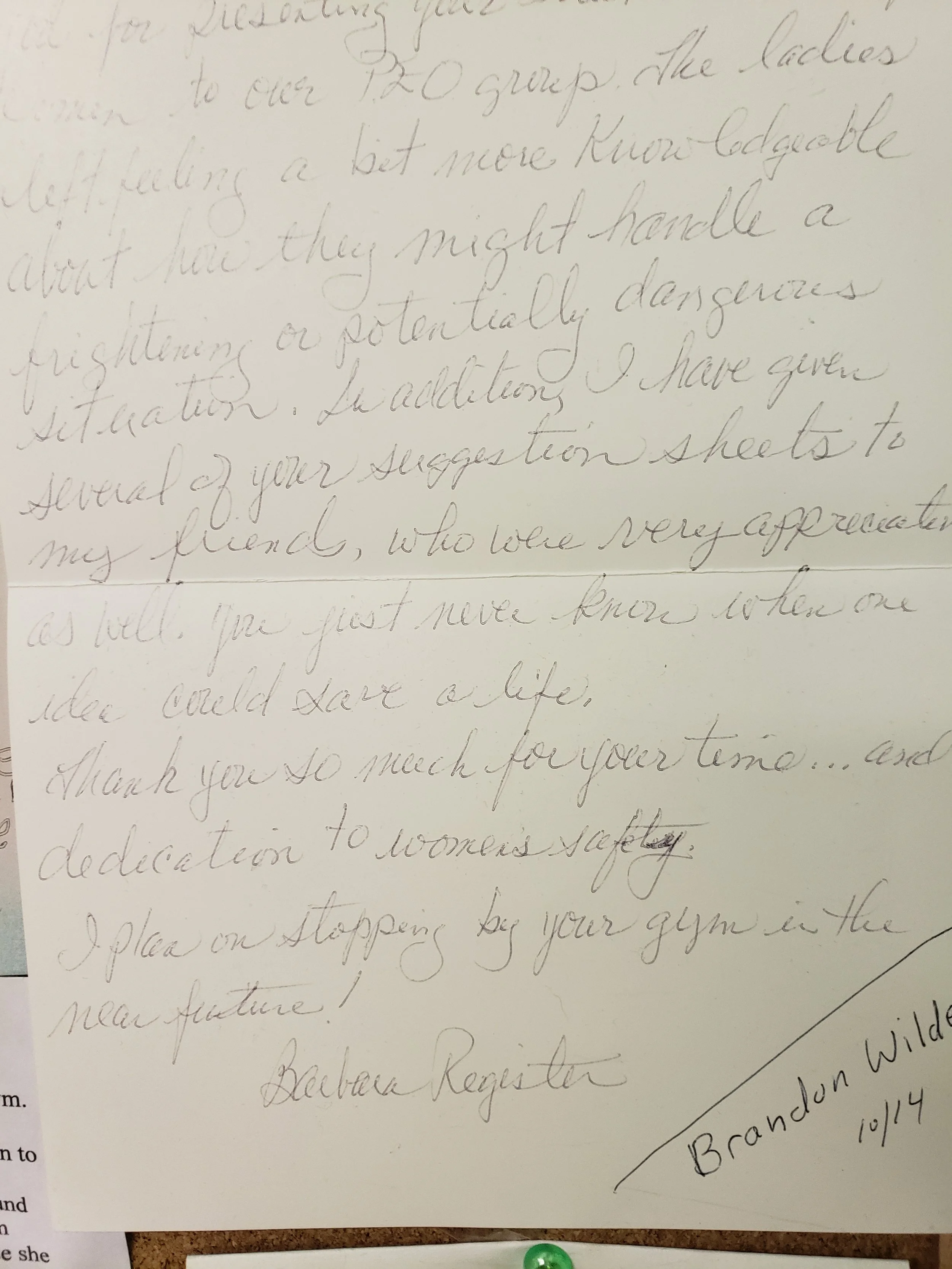 Close-up of a handwritten letter on paper, signed by Deborah Register from Brandon Wald on 10/14.