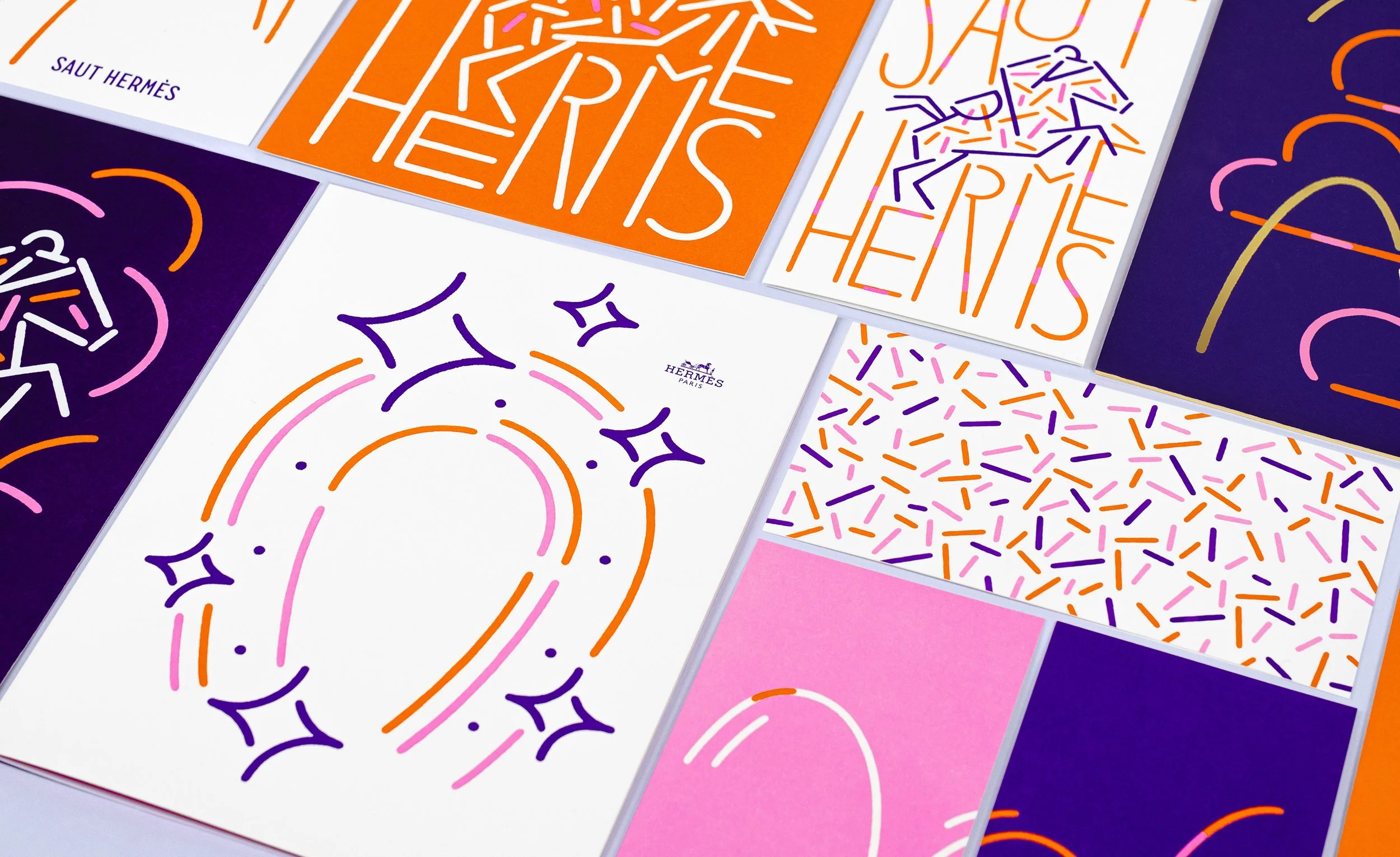 Diverses affiches et emballages de la marque Hermès avec des designs colorés, notamment des illustrations abstraites et des motifs de confettis en couleurs orange, violet, rose et blanc.