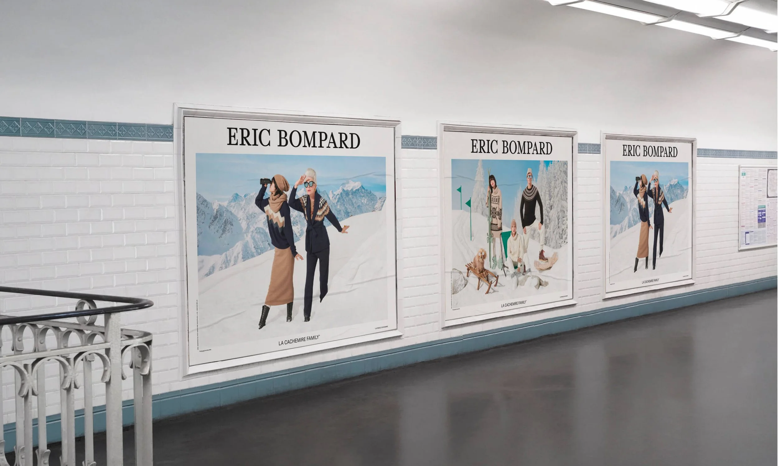 Affiches publicitaires d'un artiste nommé Eric Bompard dans un tunnel, avec des images de personnes en vêtements d'hiver dans un paysage montagneux.
