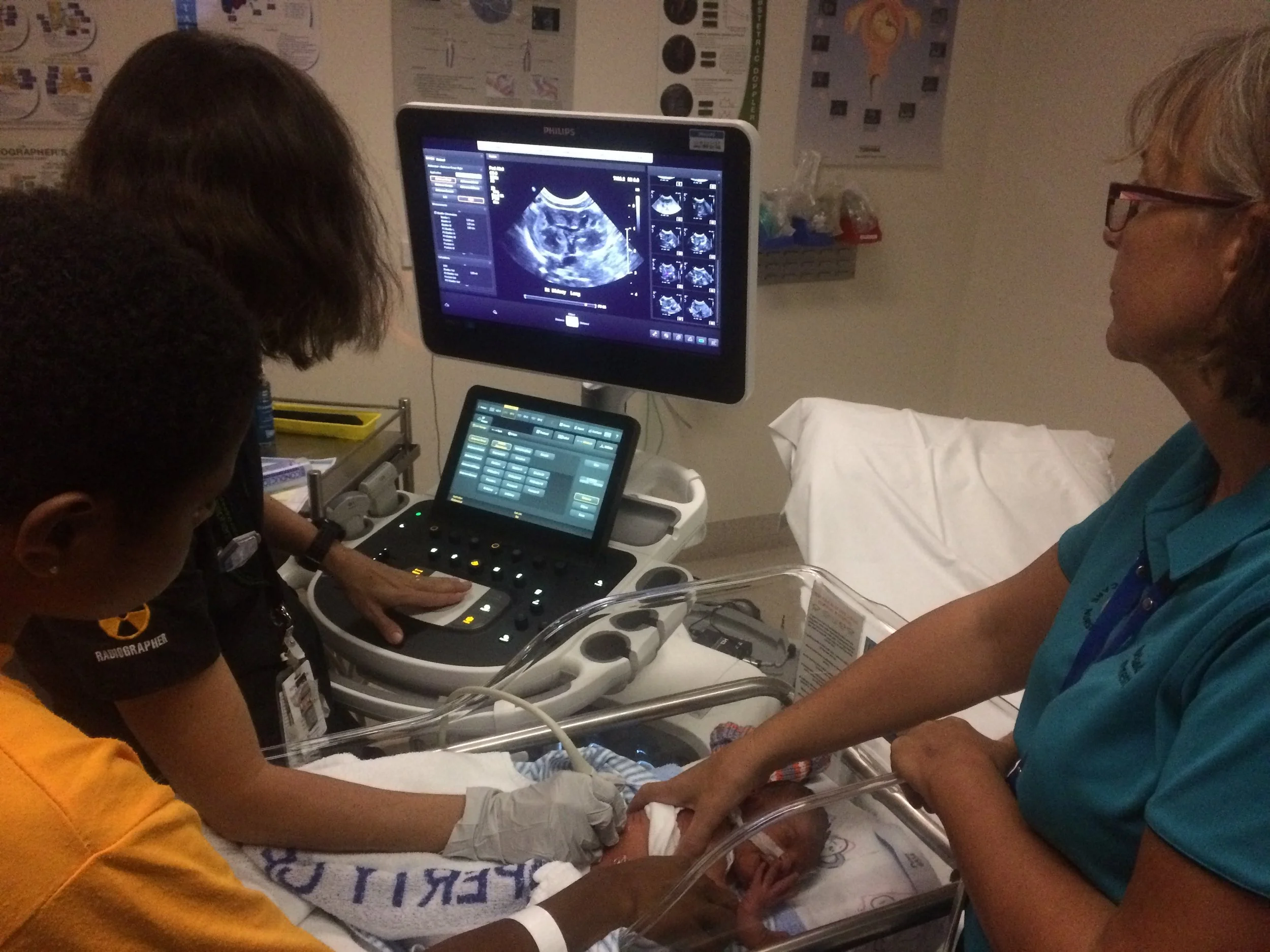 Supporting a mother and her premature baby during a scan. 