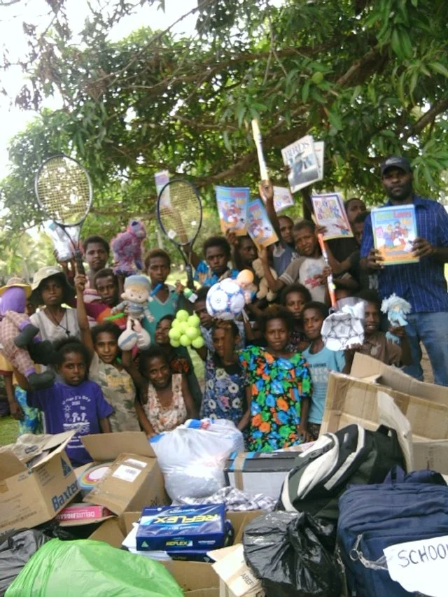 The first donations to the school arriving and the children and staff unpacking them.