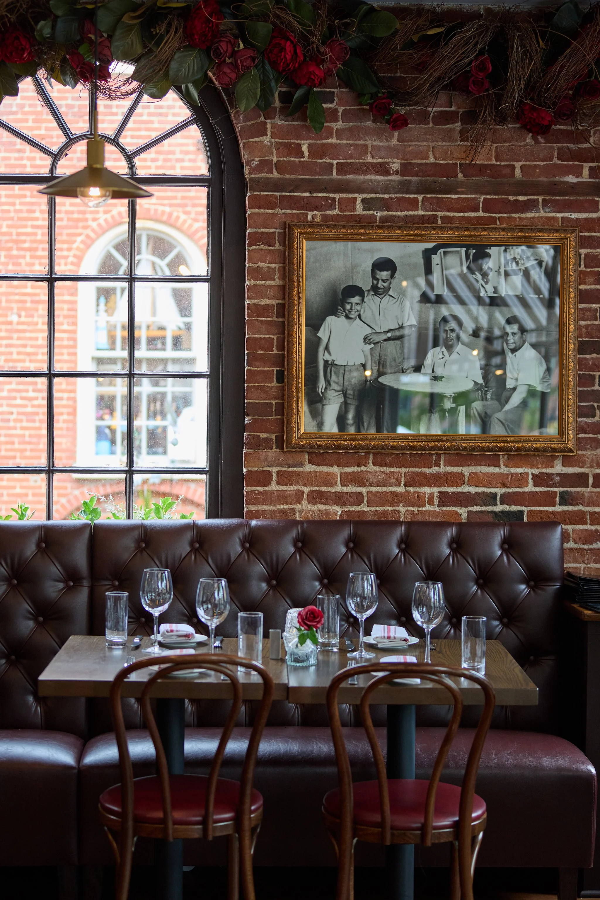 Italian family enjoying a cozy booth at LaRosa's Italian Newburyport, highlighting warm Sicilian hospitality and inviting restaurant interior