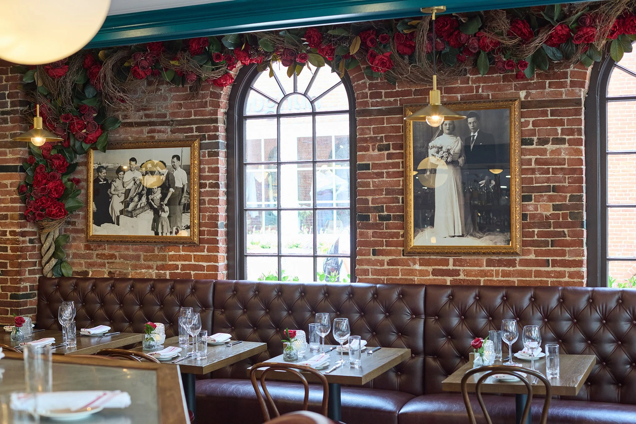 Warm Italian restaurant interior at LaRosa's Italian Newburyport with exposed brick walls and cozy booth seating