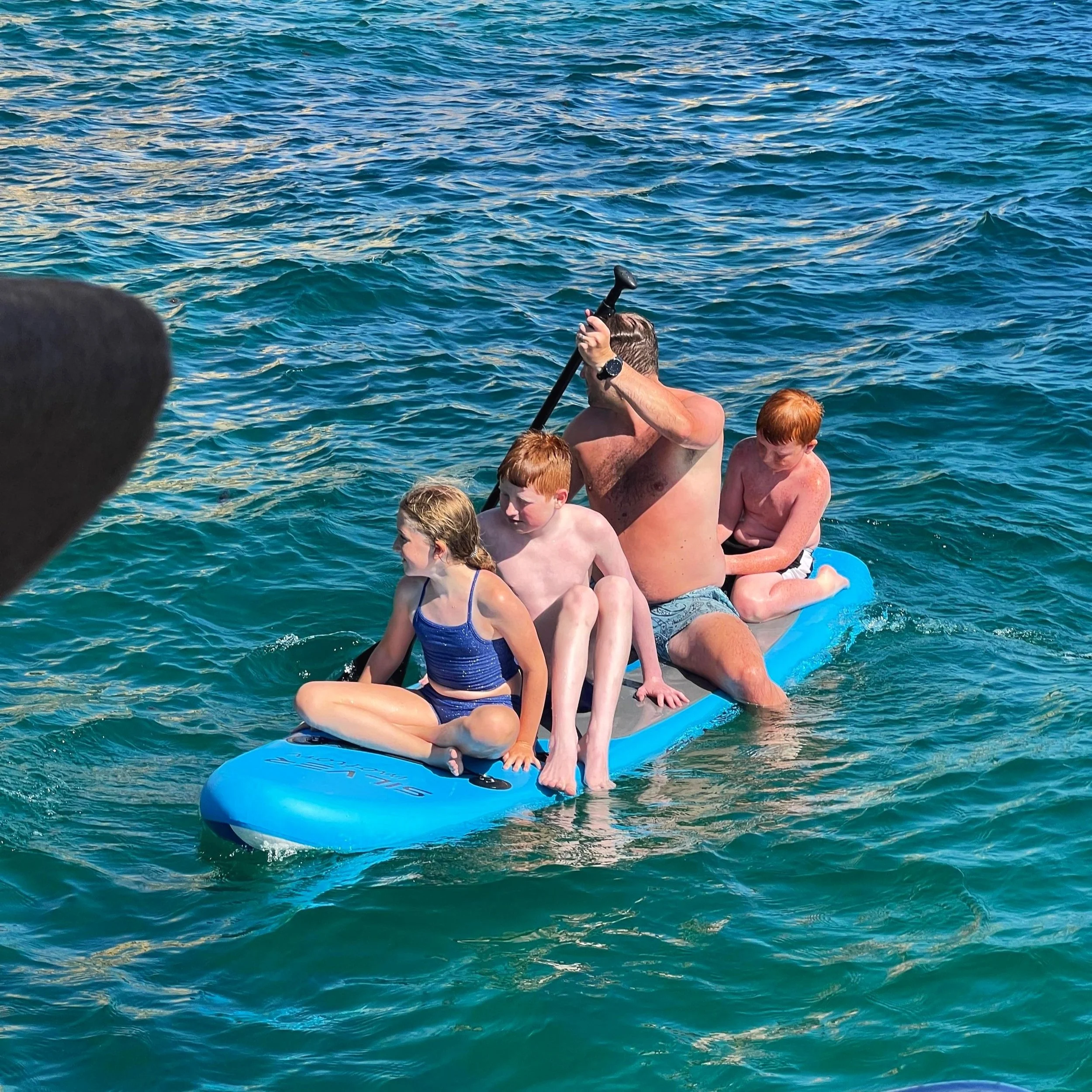 Family paddleboarding together