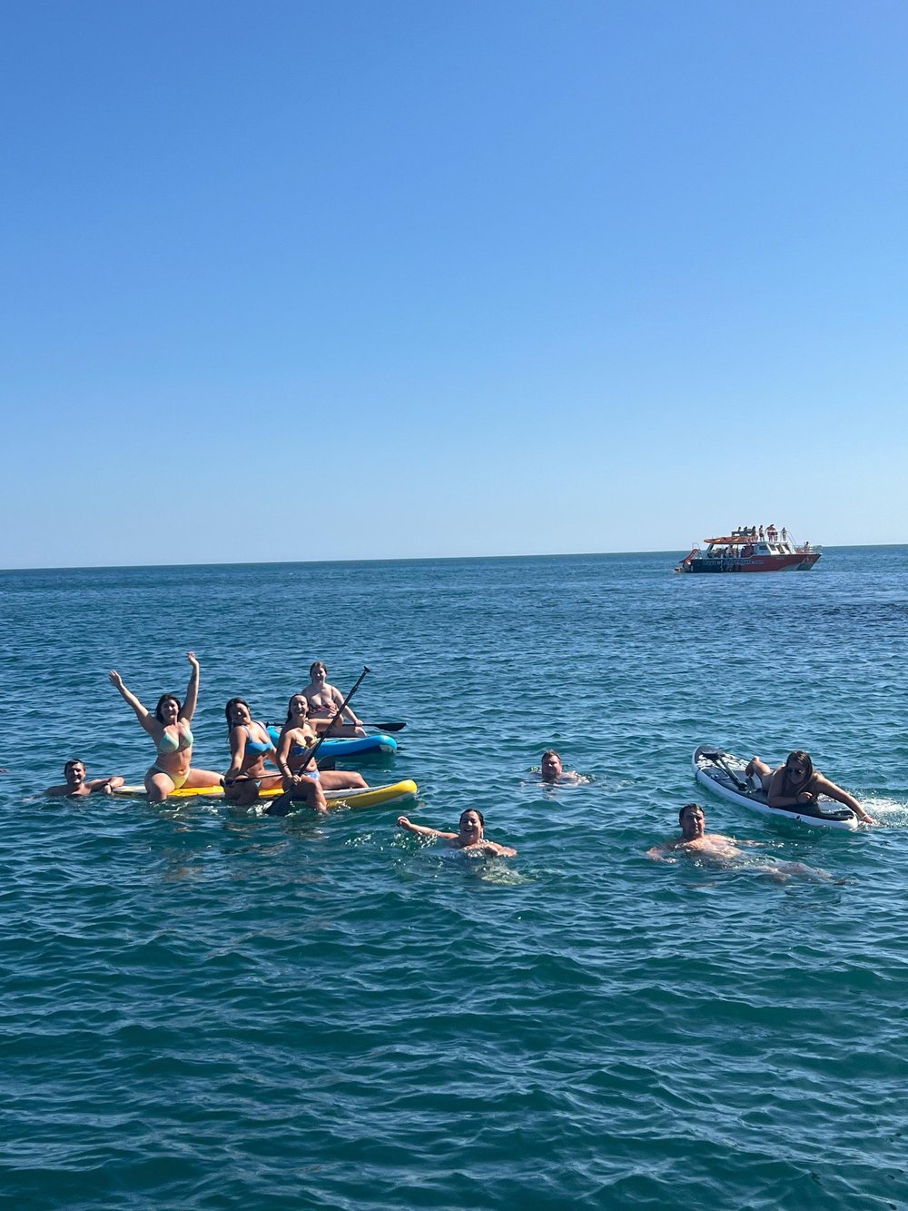Group swimming near the boat