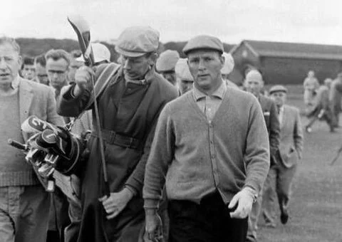 A group of men walking outdoors, with some carrying golf clubs, on a cloudy day.