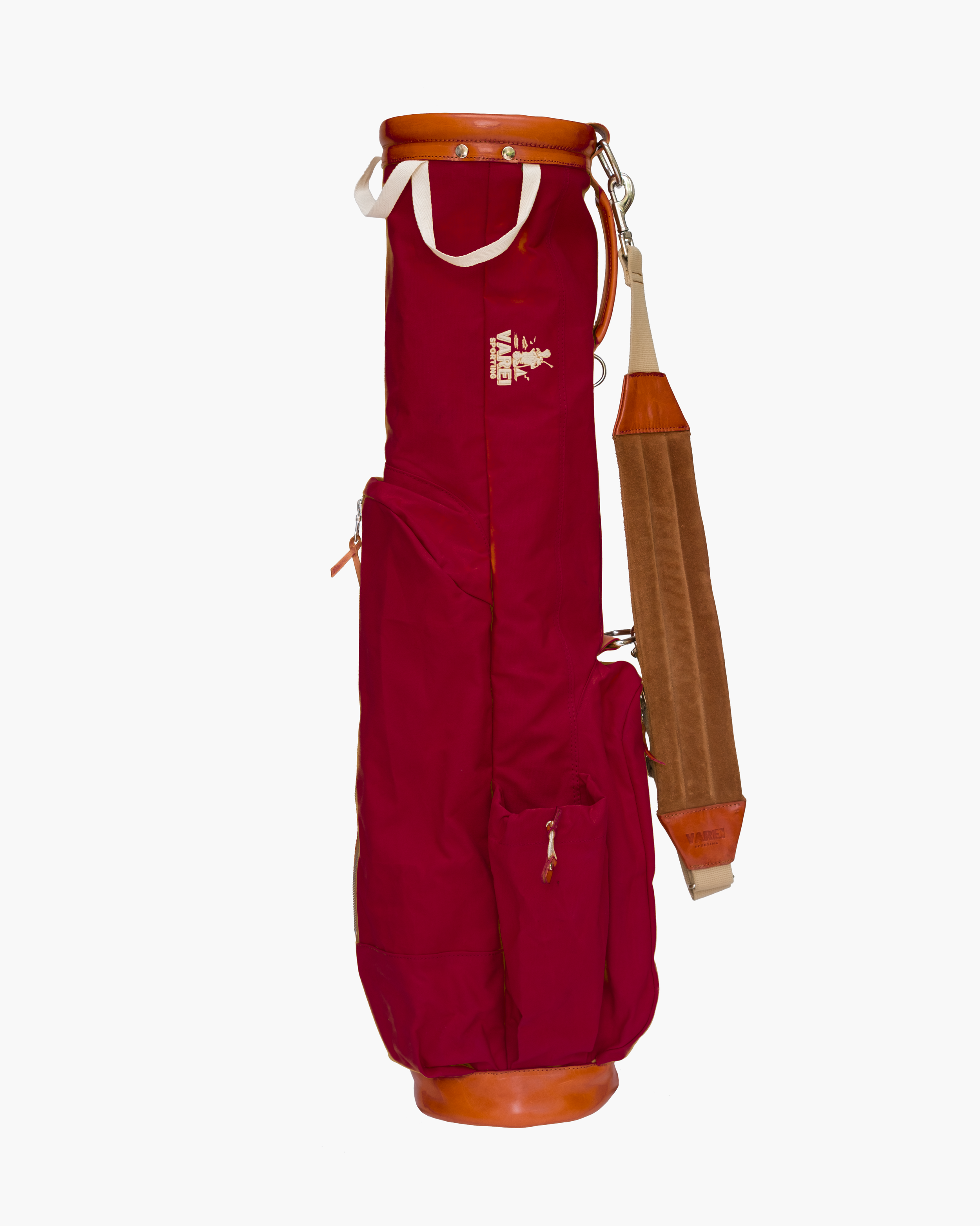 Red golf bag with leather accents and white straps, with a beige and brown shoulder strap attached.