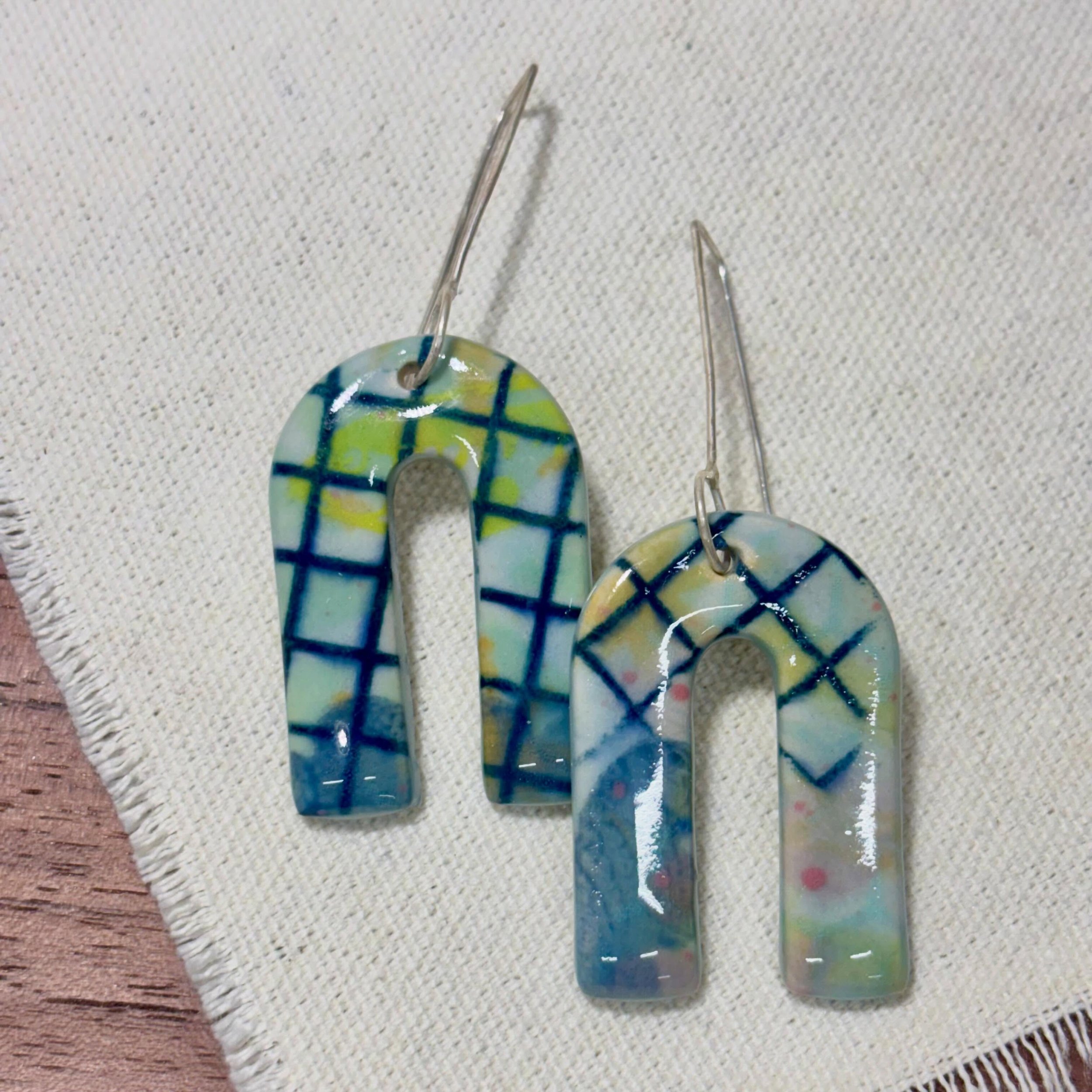 These silver + stoneware earrings combine my illustrations in playful collage designs for a look that&rsquo;s artsy, pretty, and a little unexpected.
Like tiny mixed-media pieces you can wear!

These and more will be available at Artsplosure this wee
