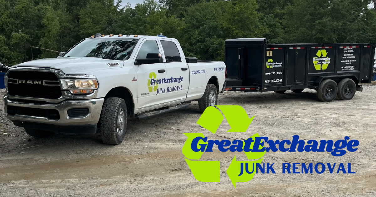 A white pickup truck and a black trailer with the Great Exchange Junk Removal logo and contact information parked on a dirt lot with trees in the background.