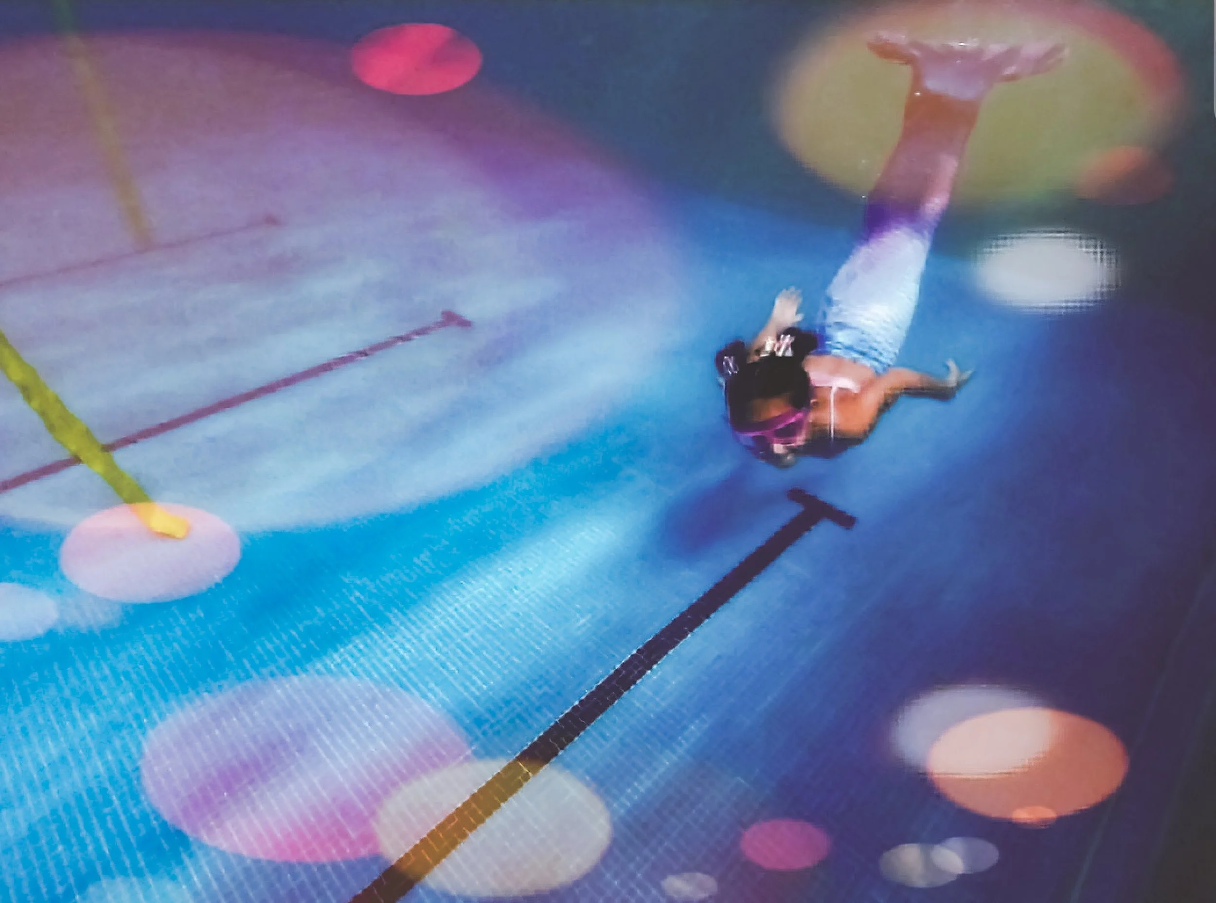 Children playing underwater mermaid games during a swim party in Dorset