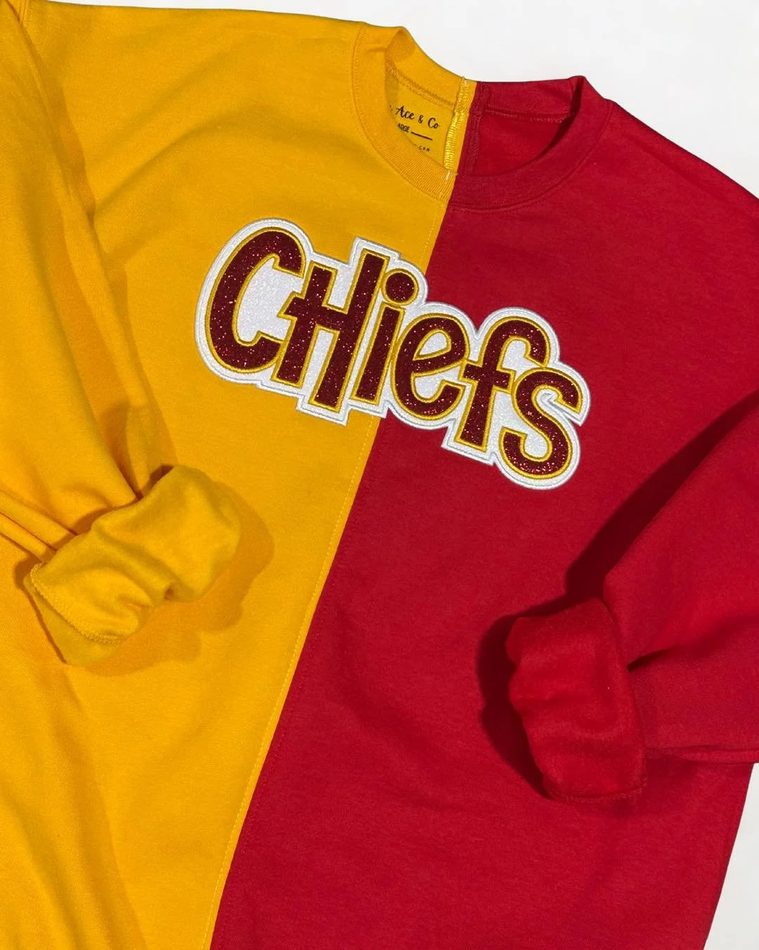 🔥 NEW DROP ALERT! 🔥

Half red, half gold, and 100% Chiefs pride! ❤️💛
This split-color sweatshirt is the perfect game day piece &mdash; bold, comfy, and finished with a glittery applique that shines just like your team spirit ✨

🏈 Pair it with you