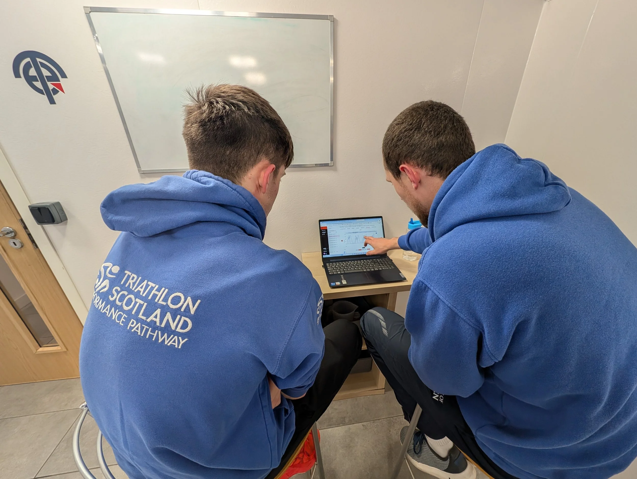 Athlete reviewing swim propulsion report data on laptop at Total Endurance facility Aberdeen