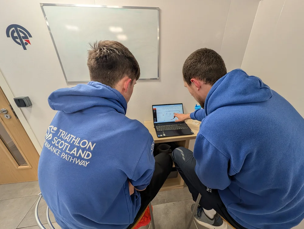Coach reviewing EO SwimBETTER propulsion data with a swimmer