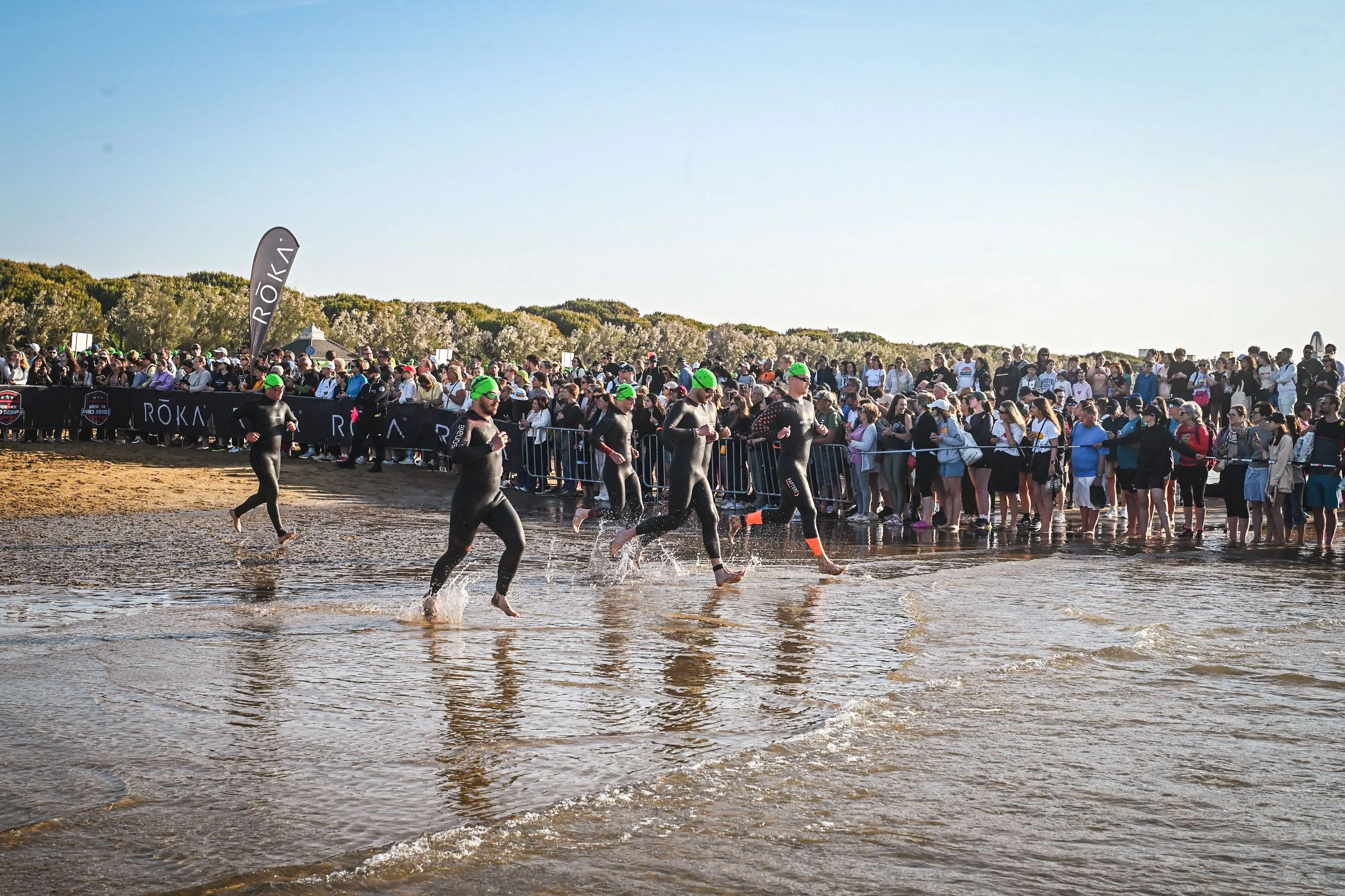 Triathlete running into the water for their first ironman