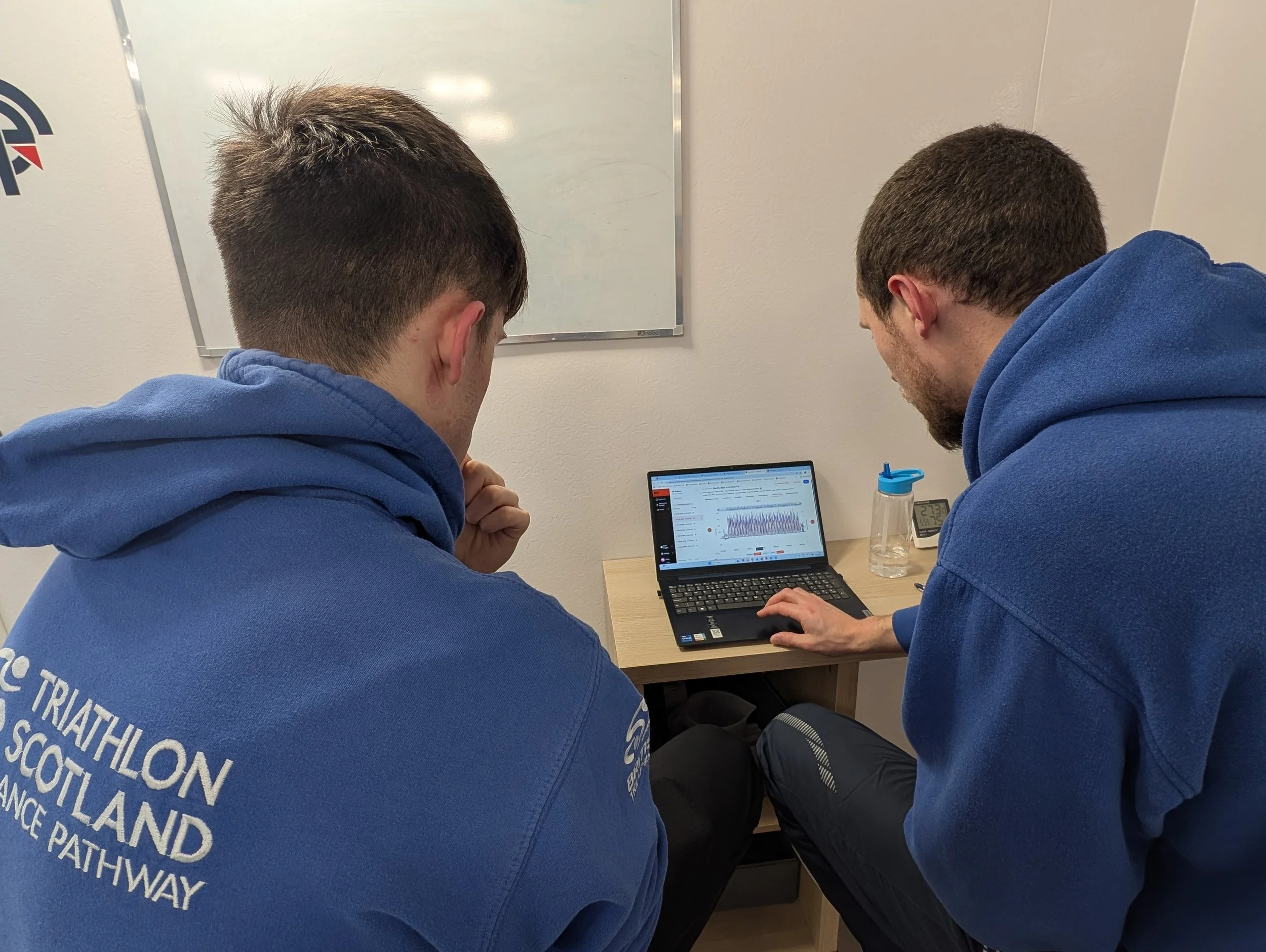 Swimmer and coach review swim data