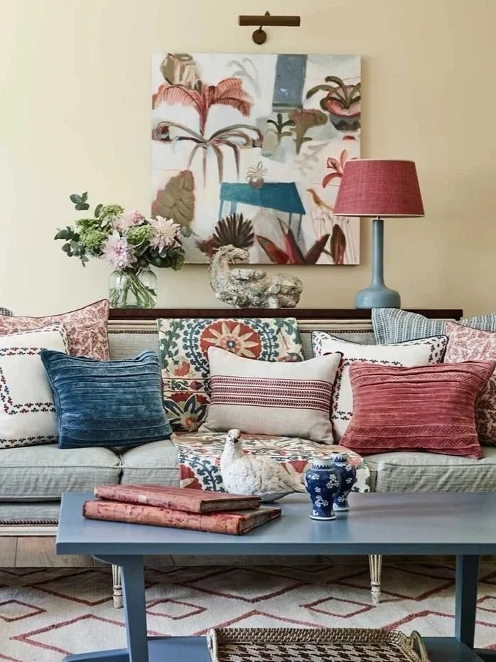 Blue soaf with pattern clashing cushions by designer Birdie Fortescue