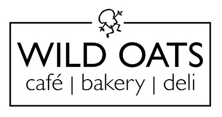 Sign for Wild Oats café, bakery, and deli with a drawing of a small figure at the top.