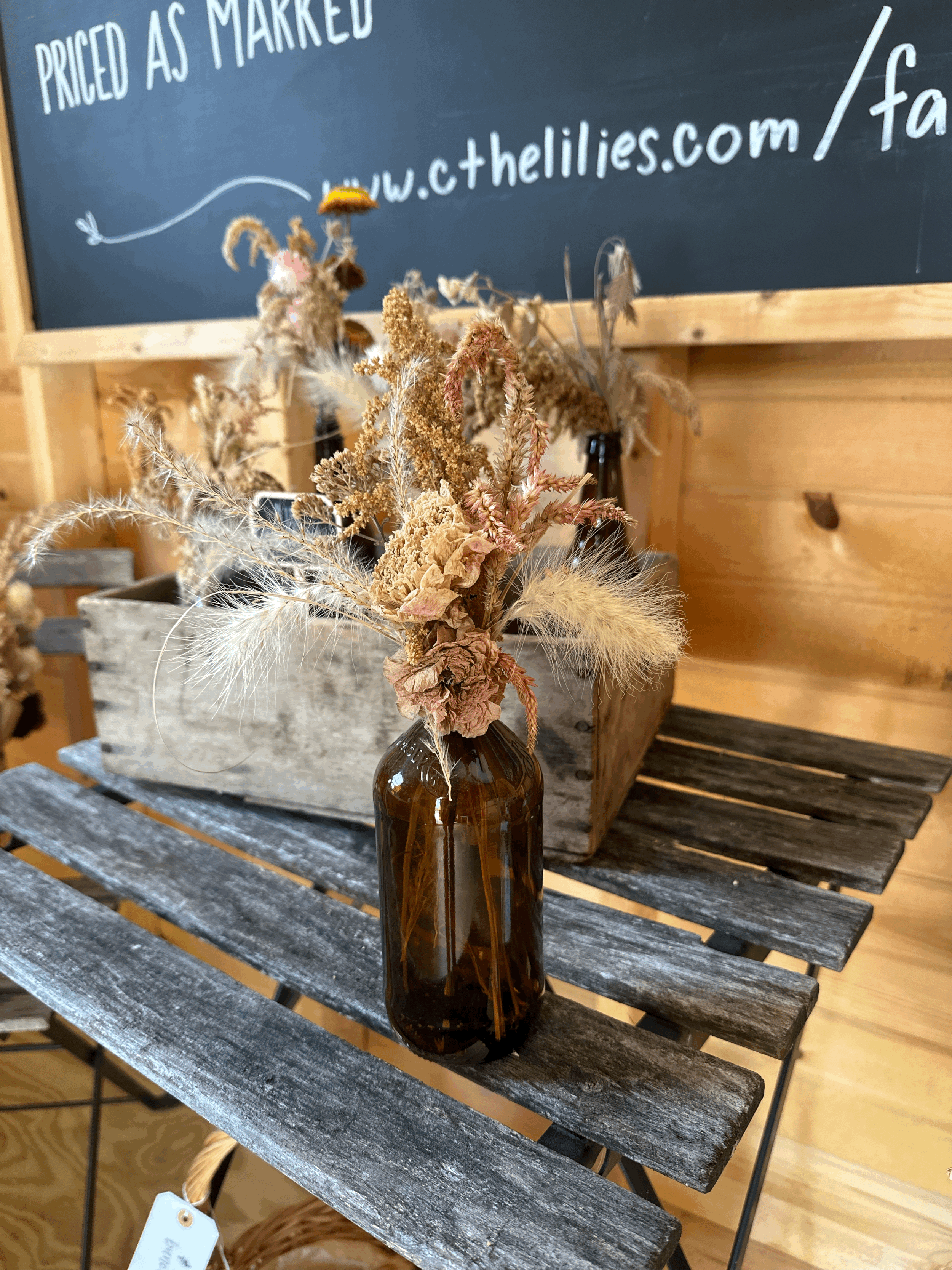 Dried Flower Arrangement in Brown Bottle