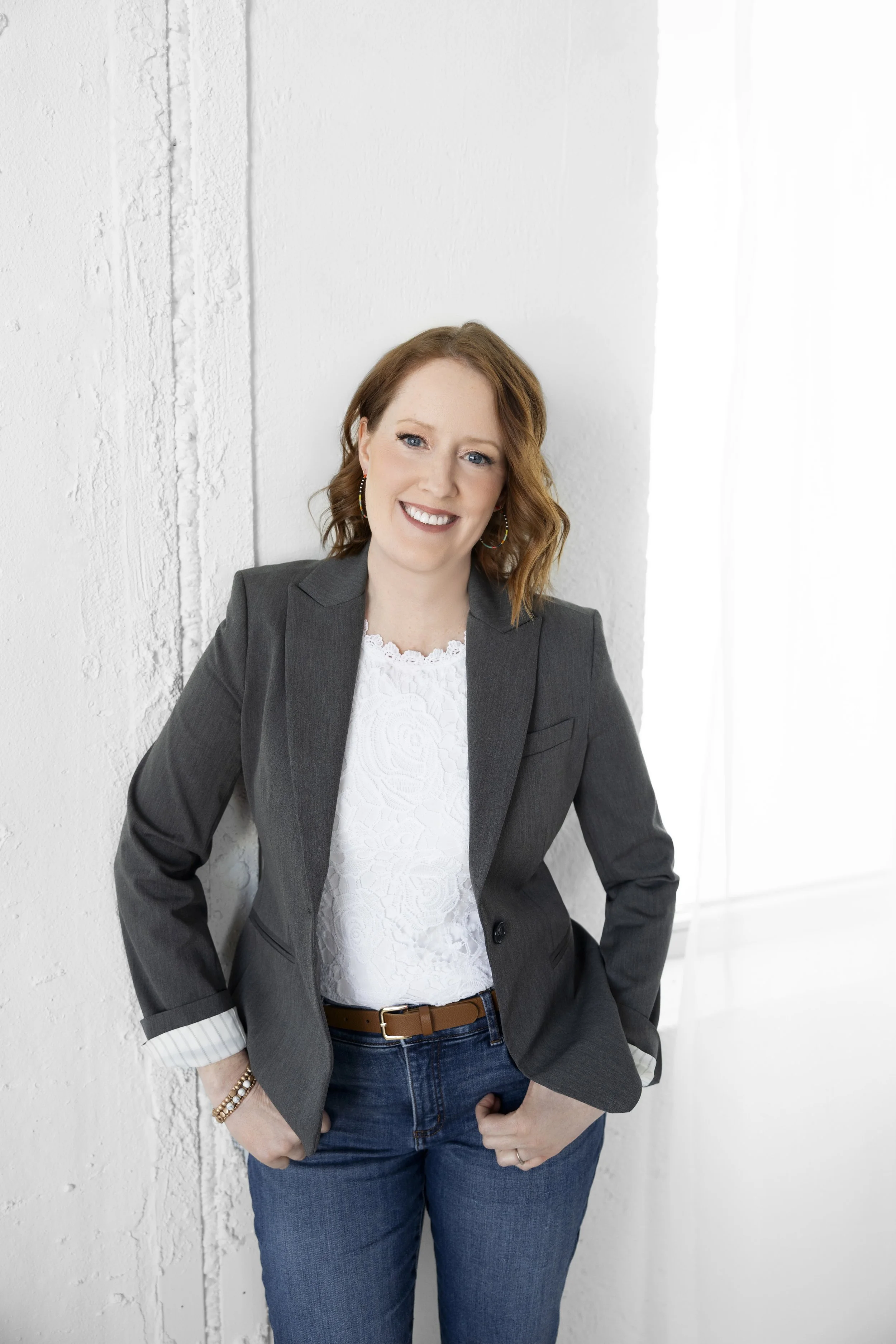 headshot of founder Liz Gaebler smiling and leaning on wall