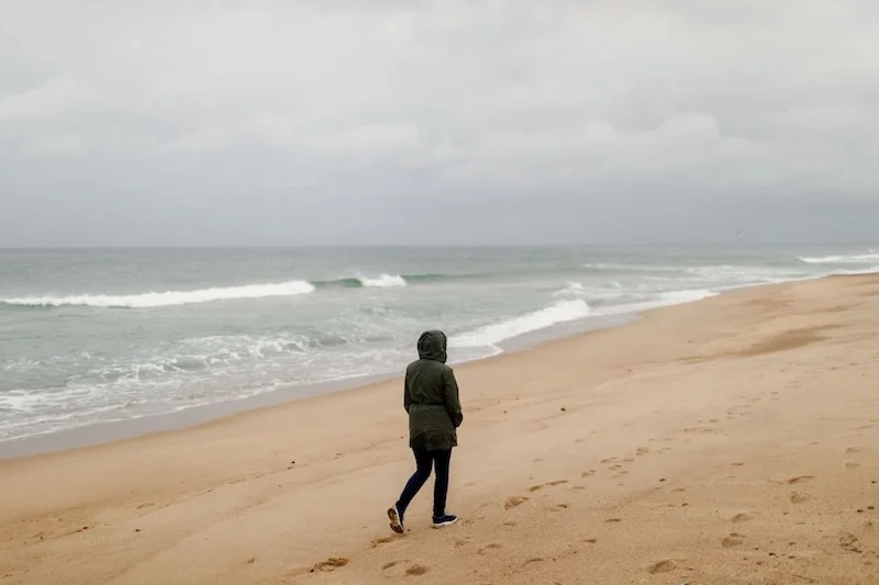 a person walking on the beach alone