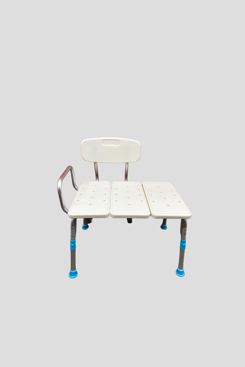 White hospital or medical waiting room chair with armrest and three connected seat sections against a red metal roll-up door.