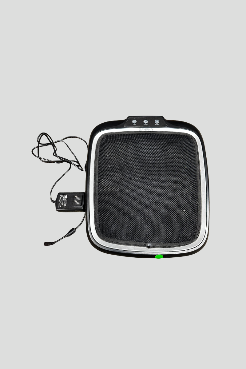 Heated foot massager on a multicolored carpet