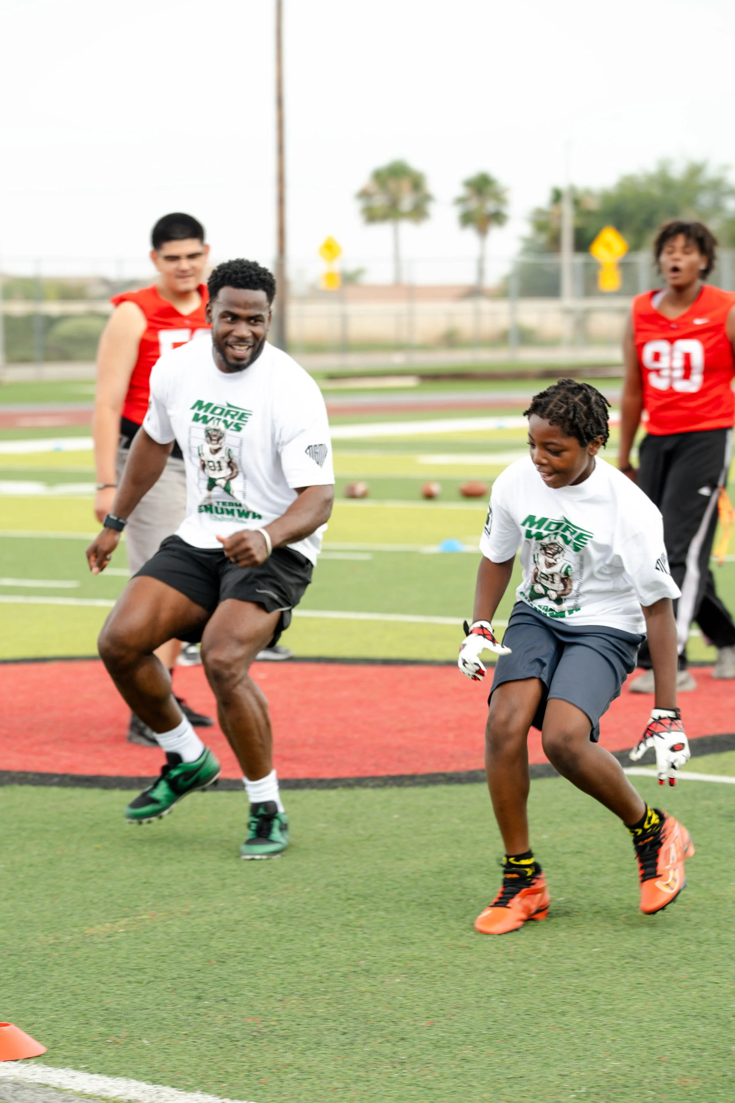 Quincy Enunwa competing with campers in drills 