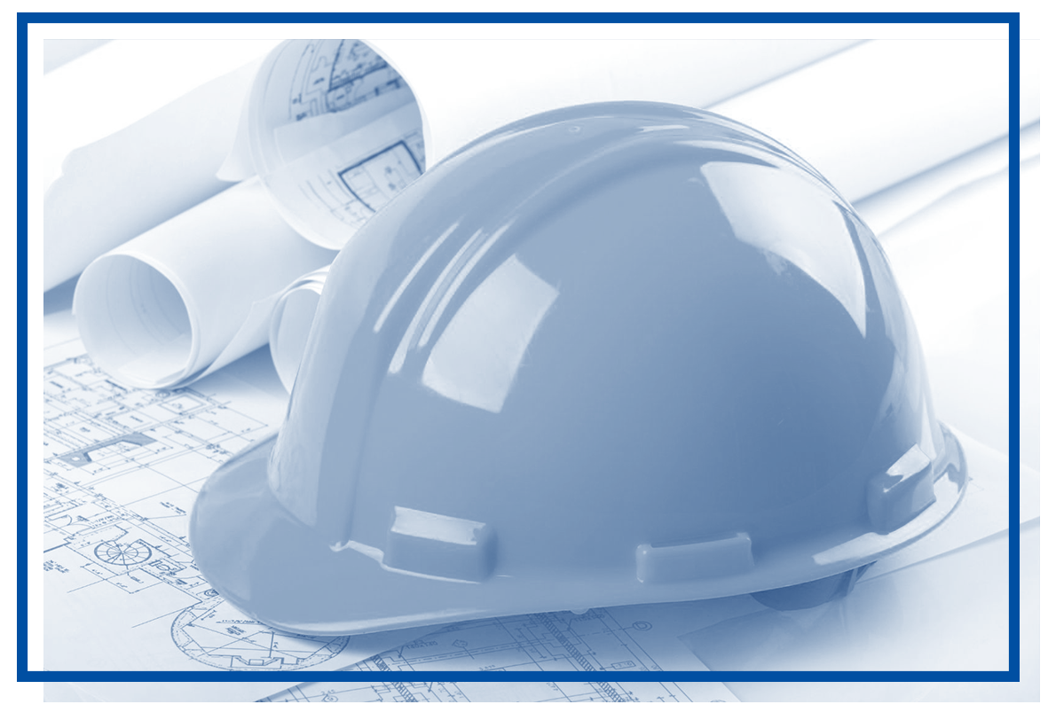 Blue construction helmet on architectural blueprints and rolled plans.