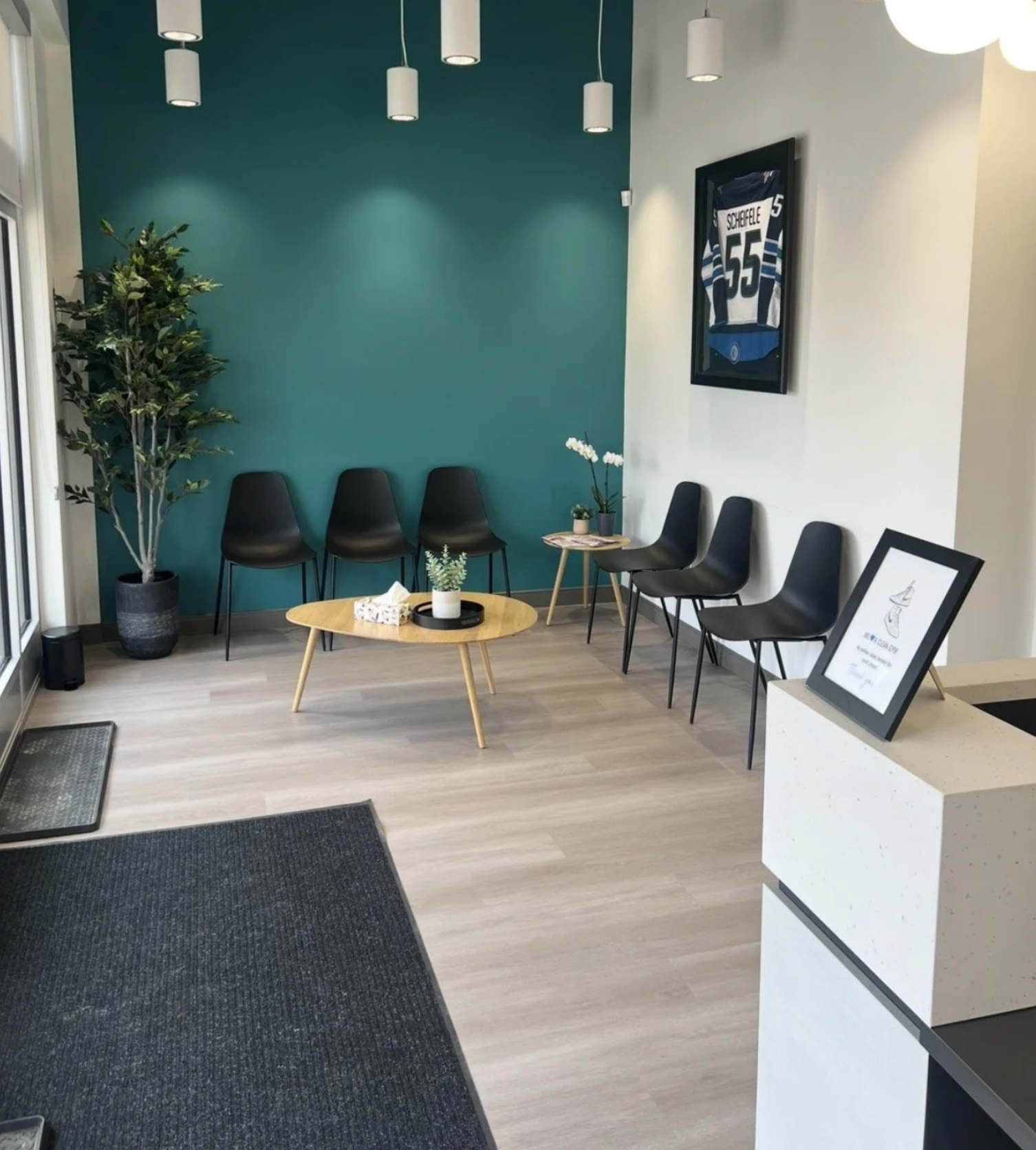 Waiting area with teal accent wall and seating