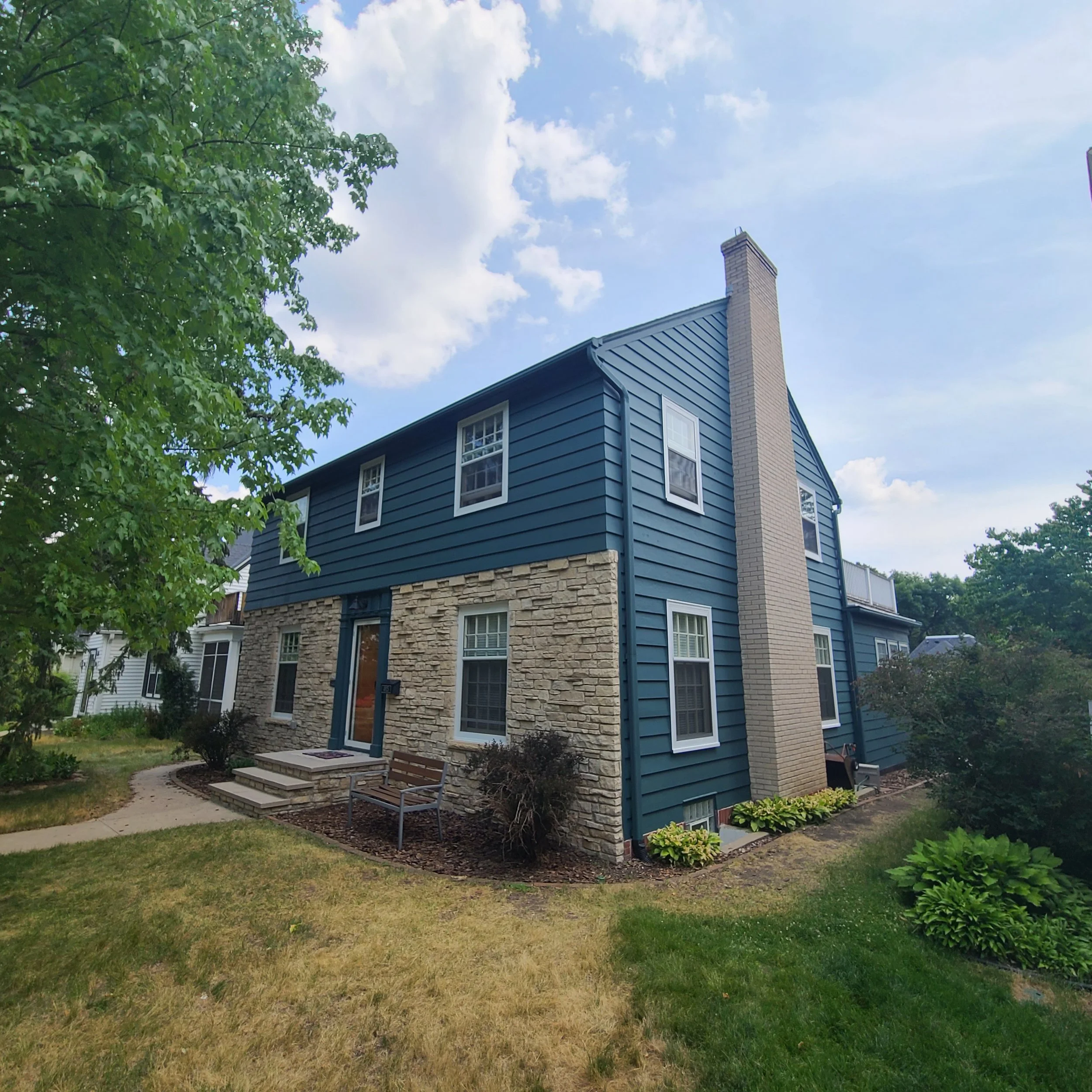 Custom teal exterior paint on a South Minneapolis home with brick front and chimney.