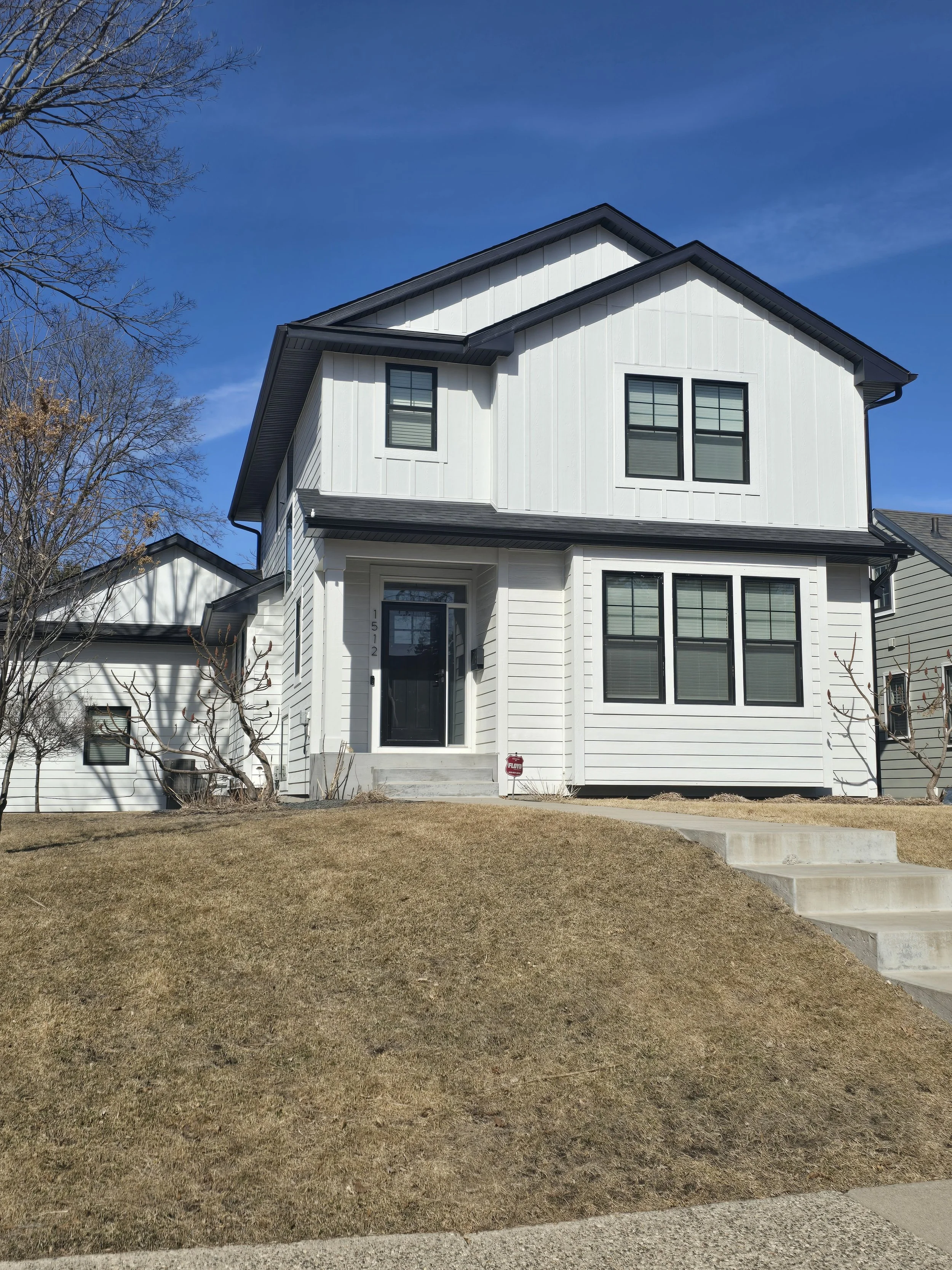 Modern white exterior paint job on a new construction home in the Lake Nokomis neighborhood, highlighting clean lines and contemporary design