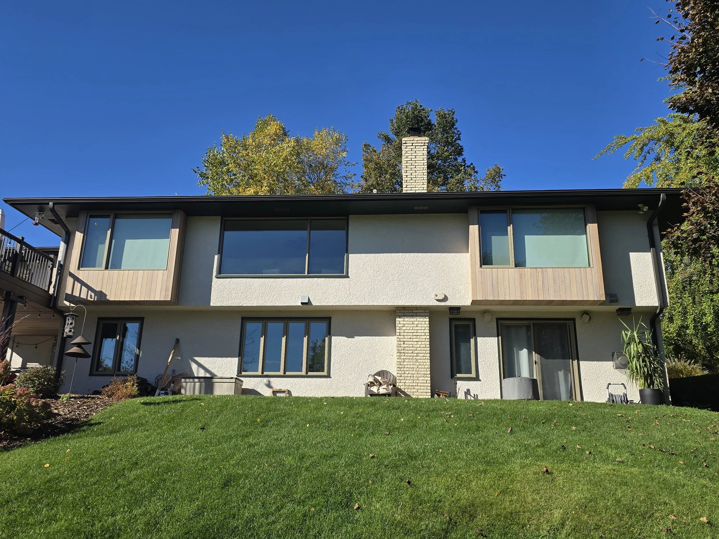 Mid-century modern exterior repaint in the Diamond Lake neighborhood, shown from the backyard perspective