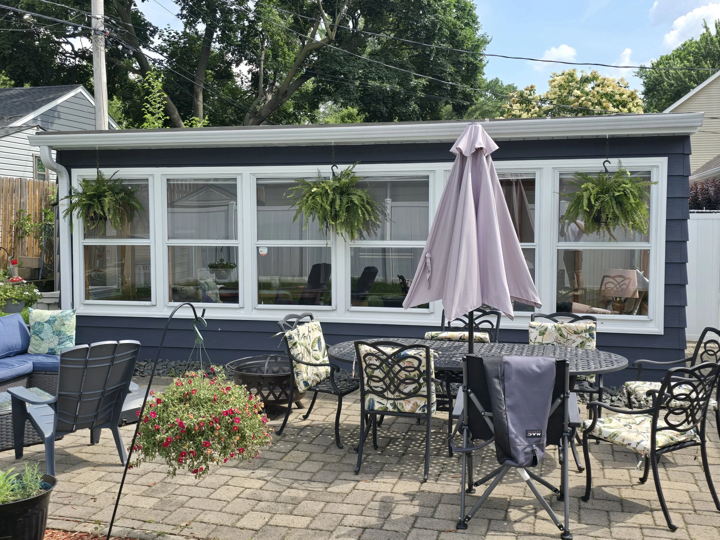 Fresh exterior repaint on a cozy Minnesota sunroom and patio space