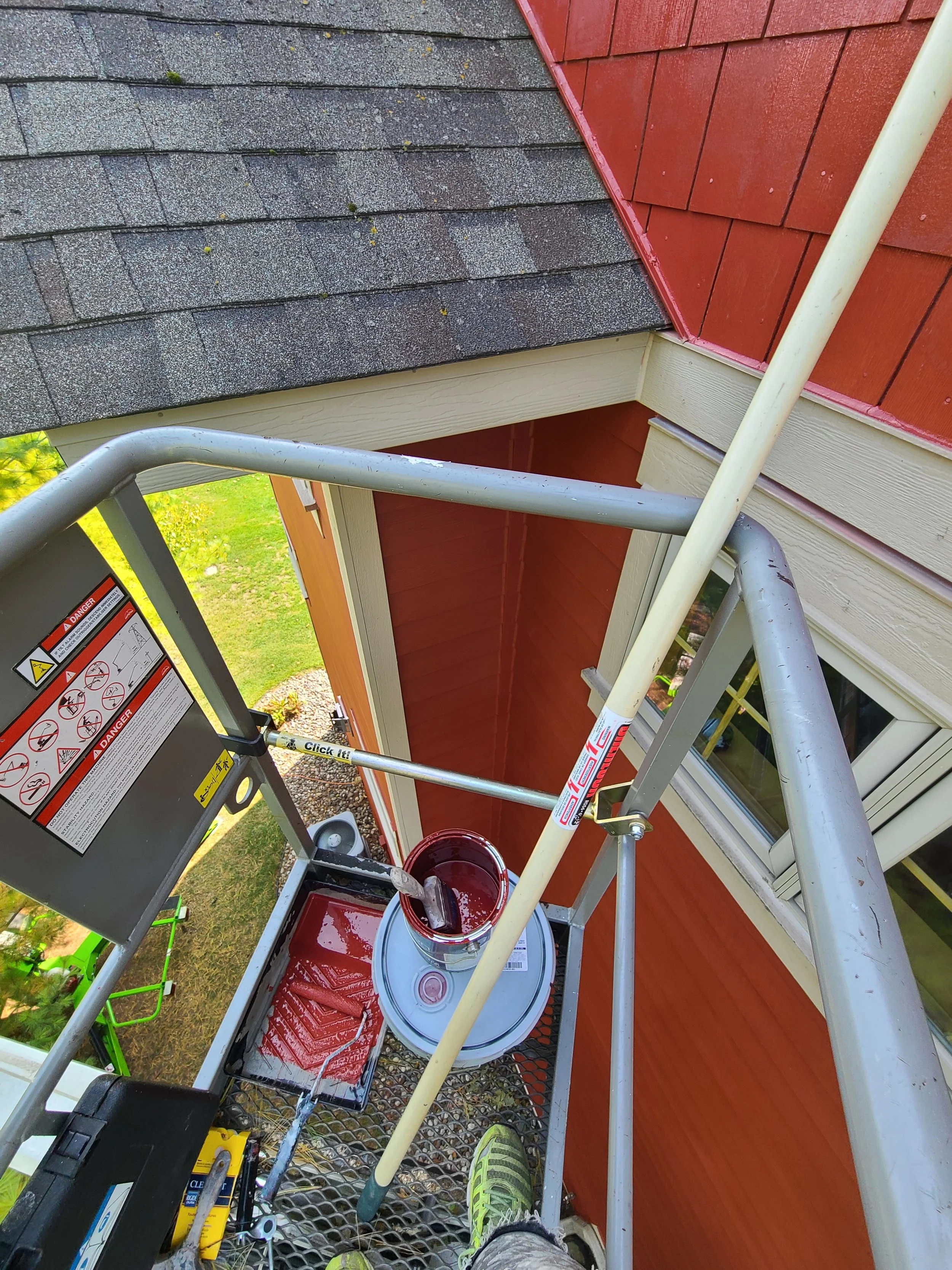 Carefully touching up high, hard-to-reach areas using a lift on this Eagan home.