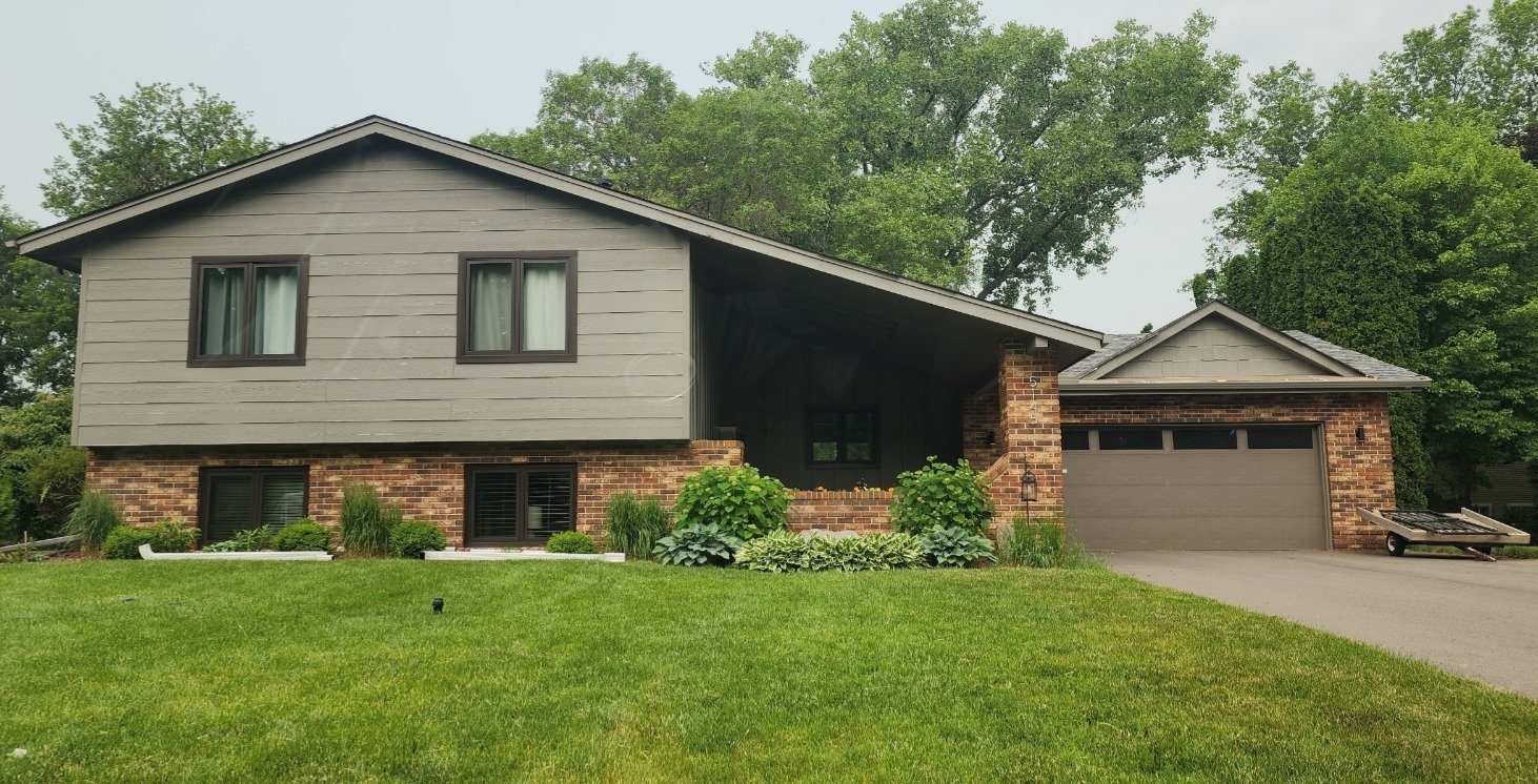 Taupe split-level exterior house painting project with brick and attached garage in Bloomington MN
