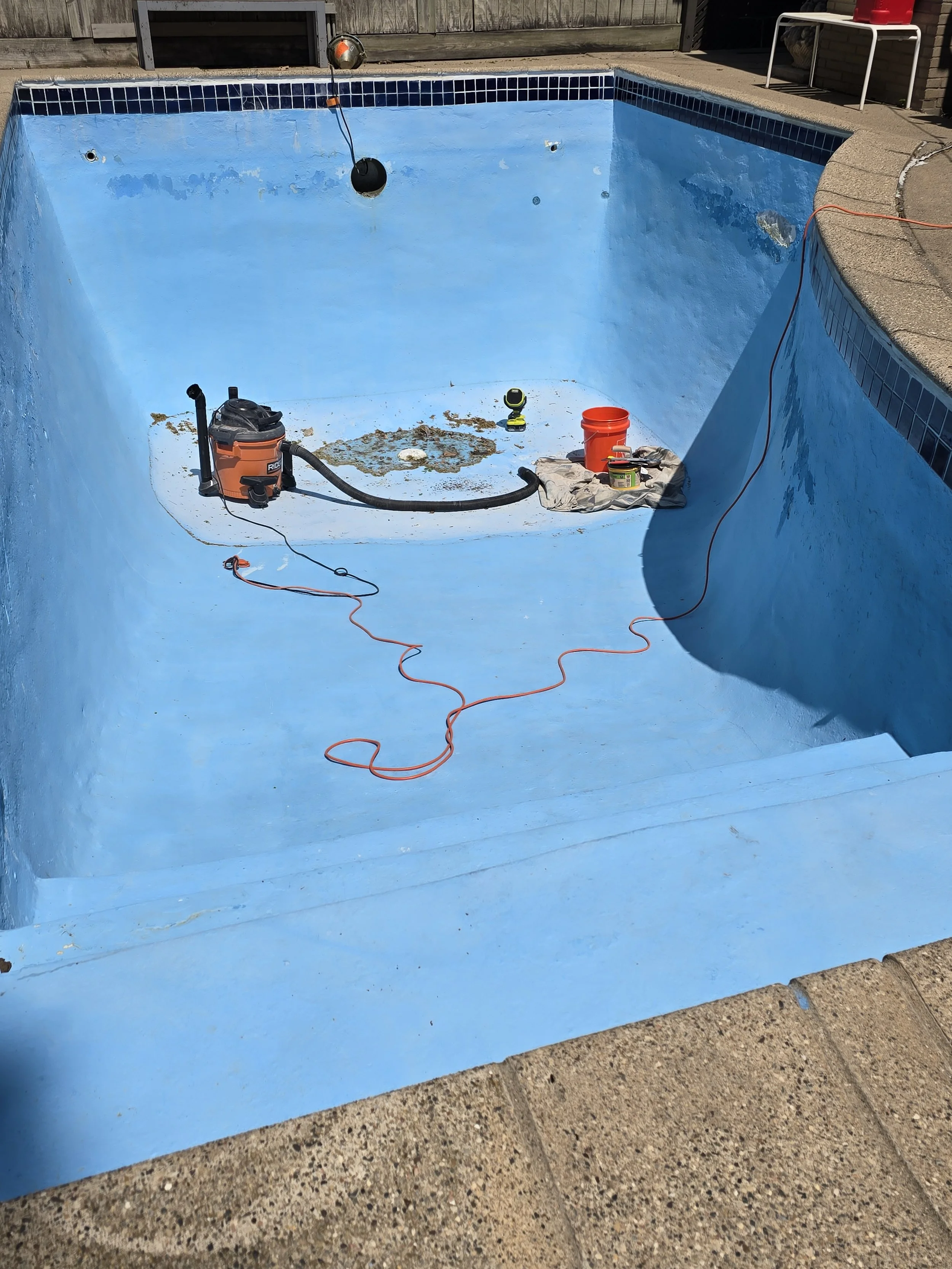 Swimming pool interior before refinishing at a Lake Harriet–area property in Minneapolis, showing worn and aged coating from years of use.