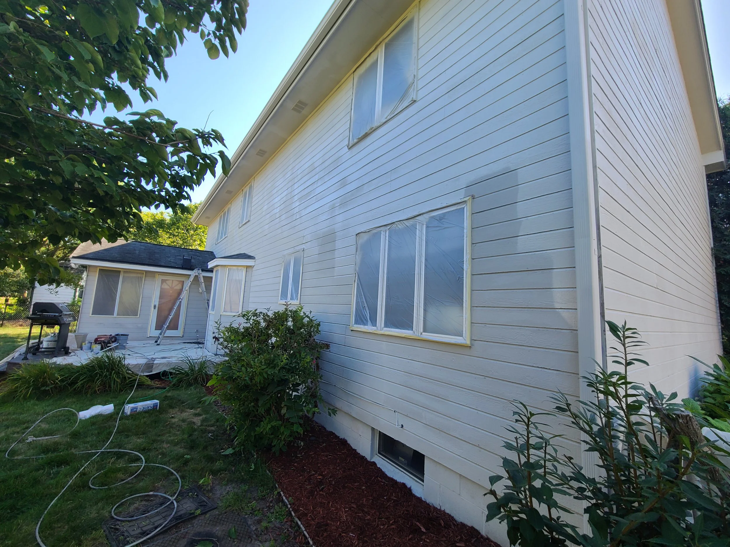 Second coat going on — building depth, durability, and a lasting finish on this Eagan home.