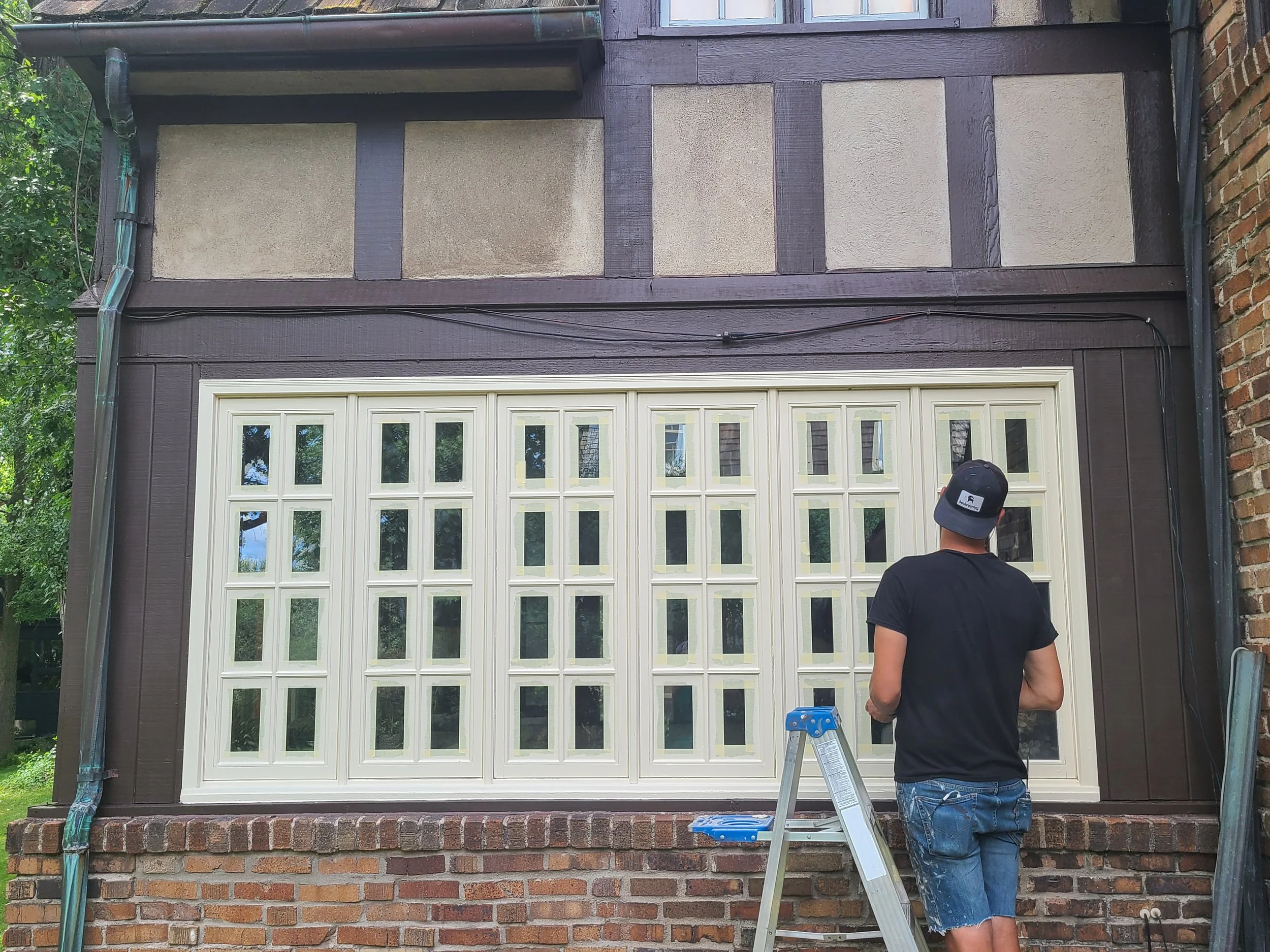 Every pane taped by hand — no shortcuts, even on multi-light Tudor windows in this Lake Harriet refresh.