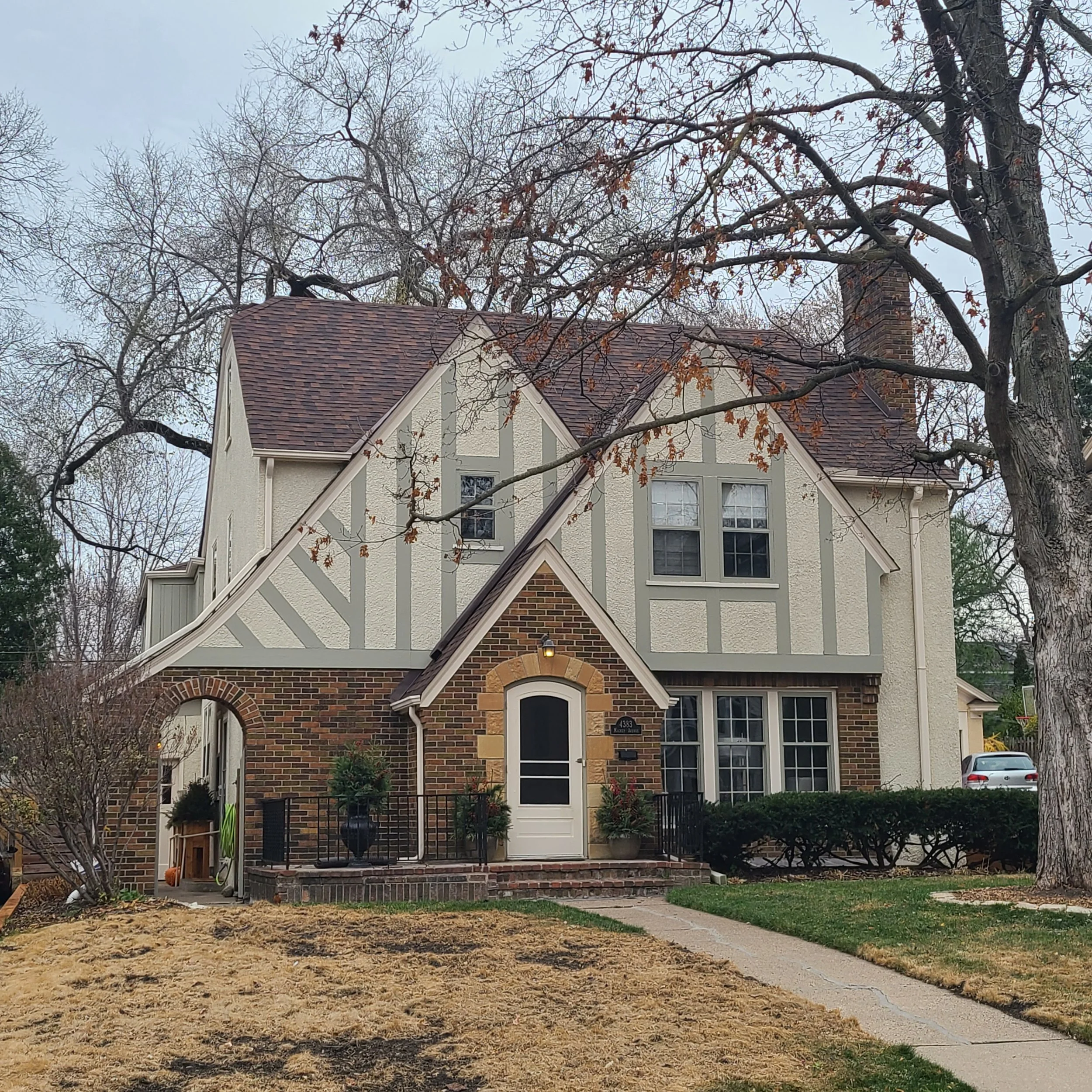 Tudor-style exterior repaint in Edina’s Arden Park neighborhood with updated siding color and detailed trim work