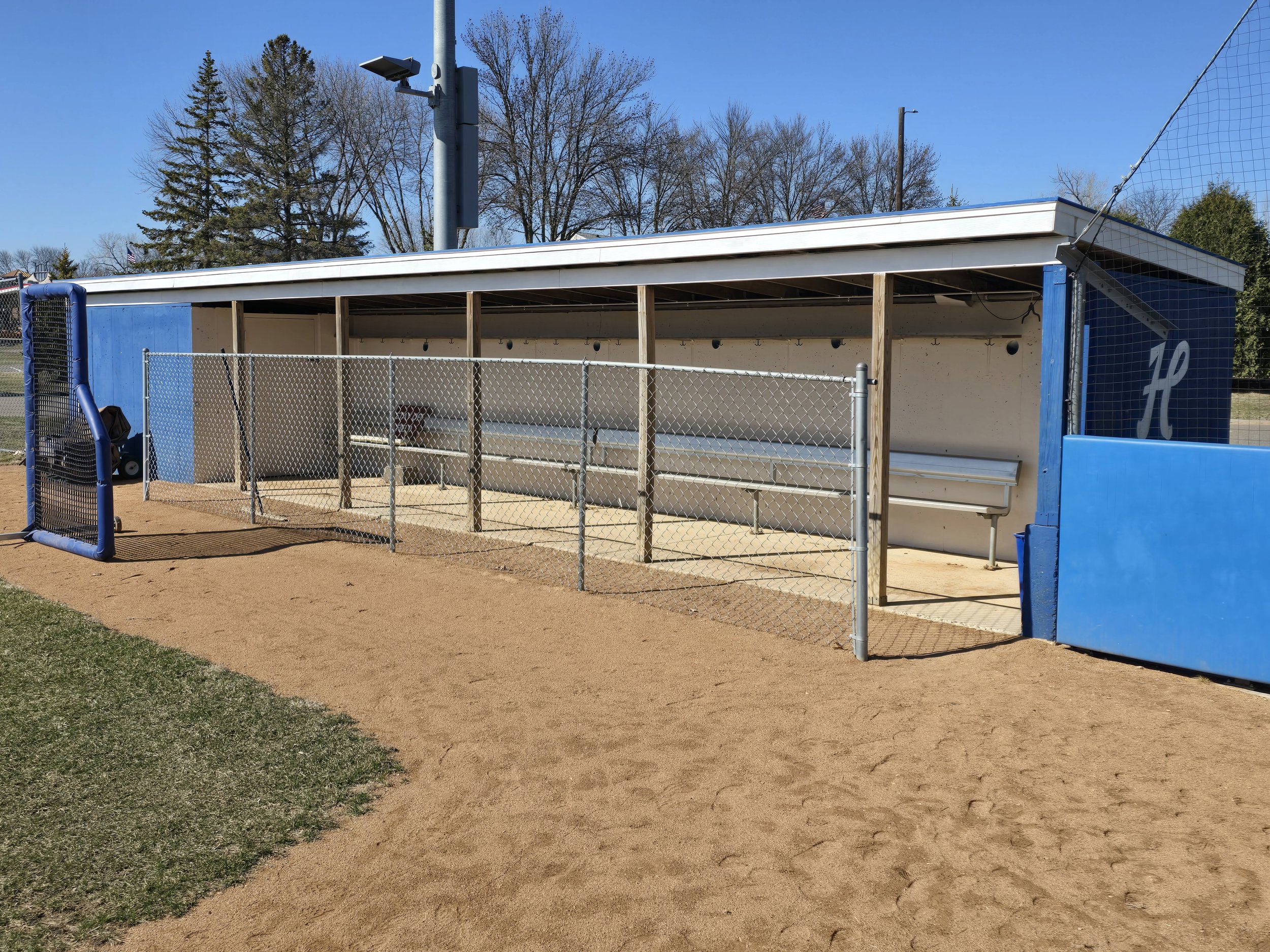 Repainted baseball dugout at a Minneapolis community field, covering graffiti and restoring a clean, durable finish.