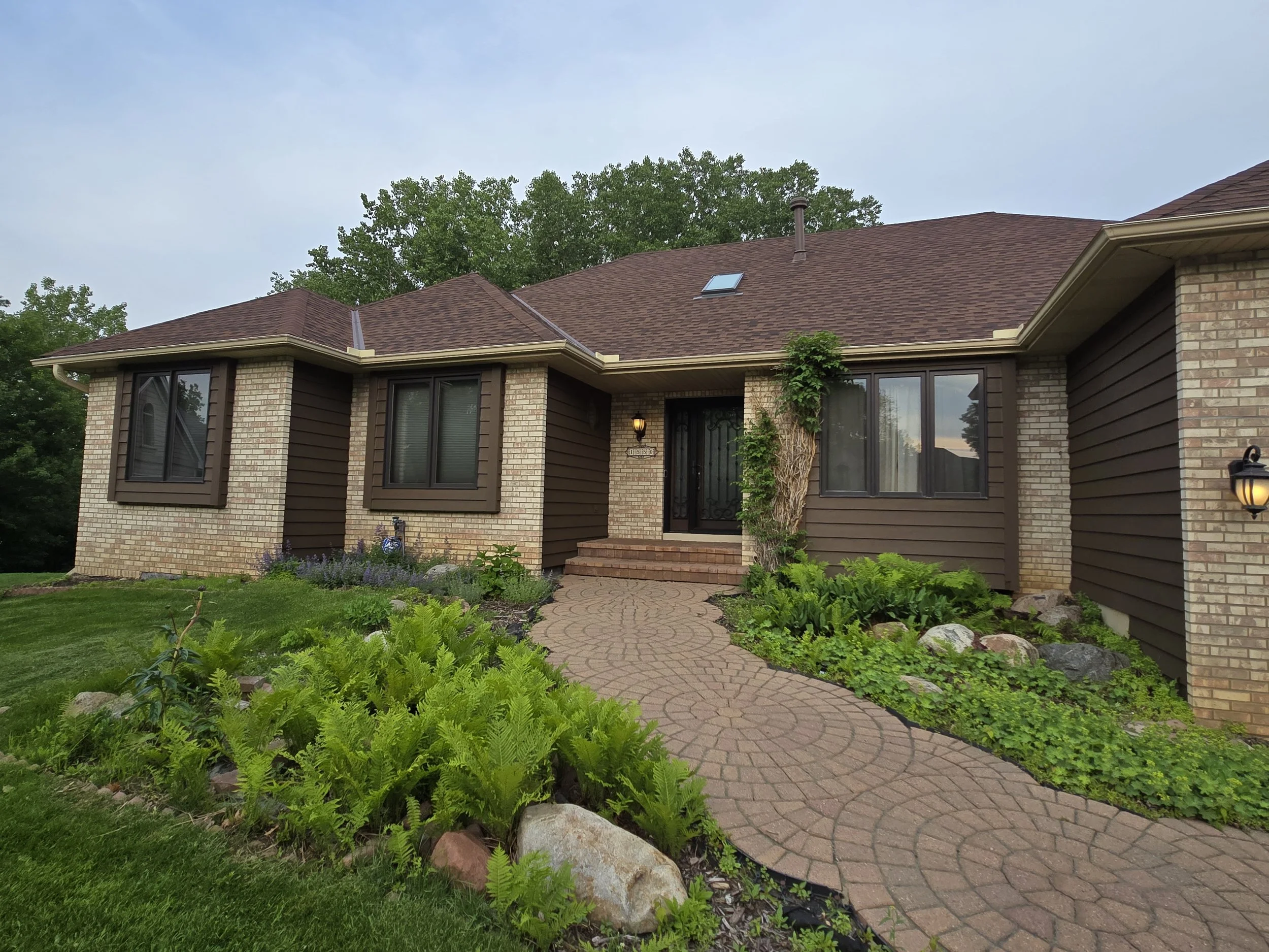 Rich brown exterior repaint paired with light brick accents on this Bloomington home